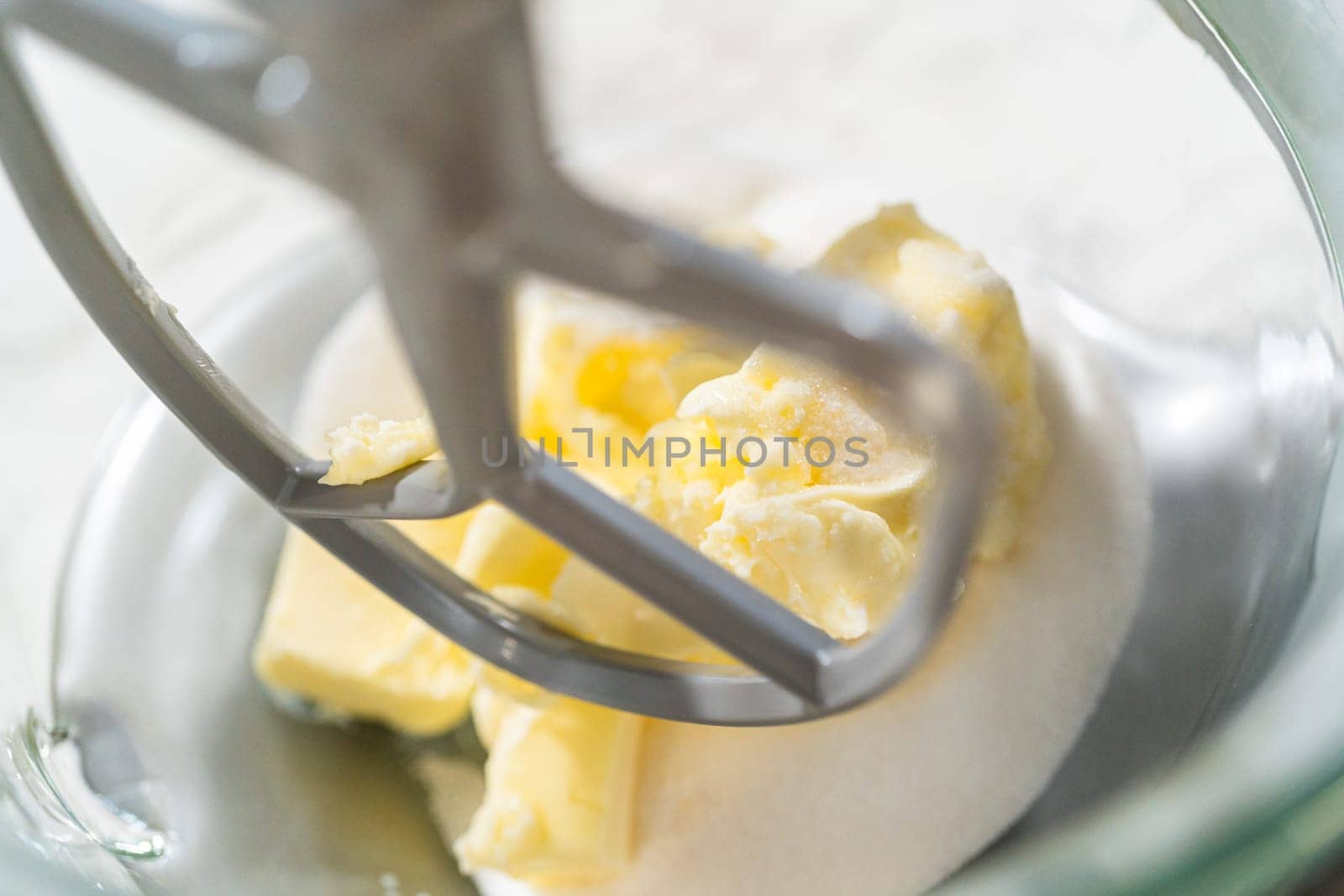 Close-up of a stand mixer creaming together butter and sugar for the Chocolate Ginger Sugar Cookie Dough, creating a light, fluffy base.
