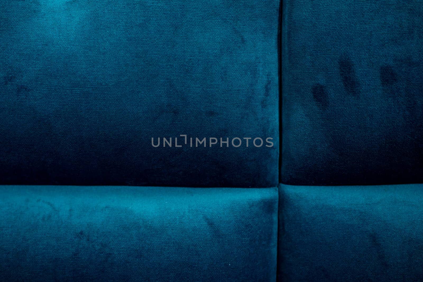 A close-up of rich blue upholstery shows texture and patterns, showcasing soft fibers and subtle variations in color. Ideal for design inspiration and textile analysis.