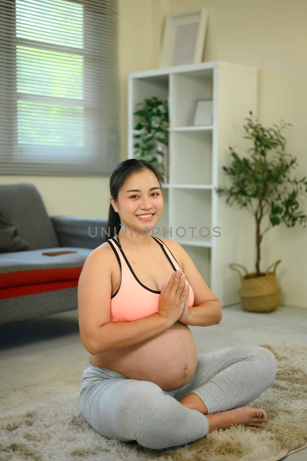 Expecting mother practicing meditation for mental calm and physical wellness.