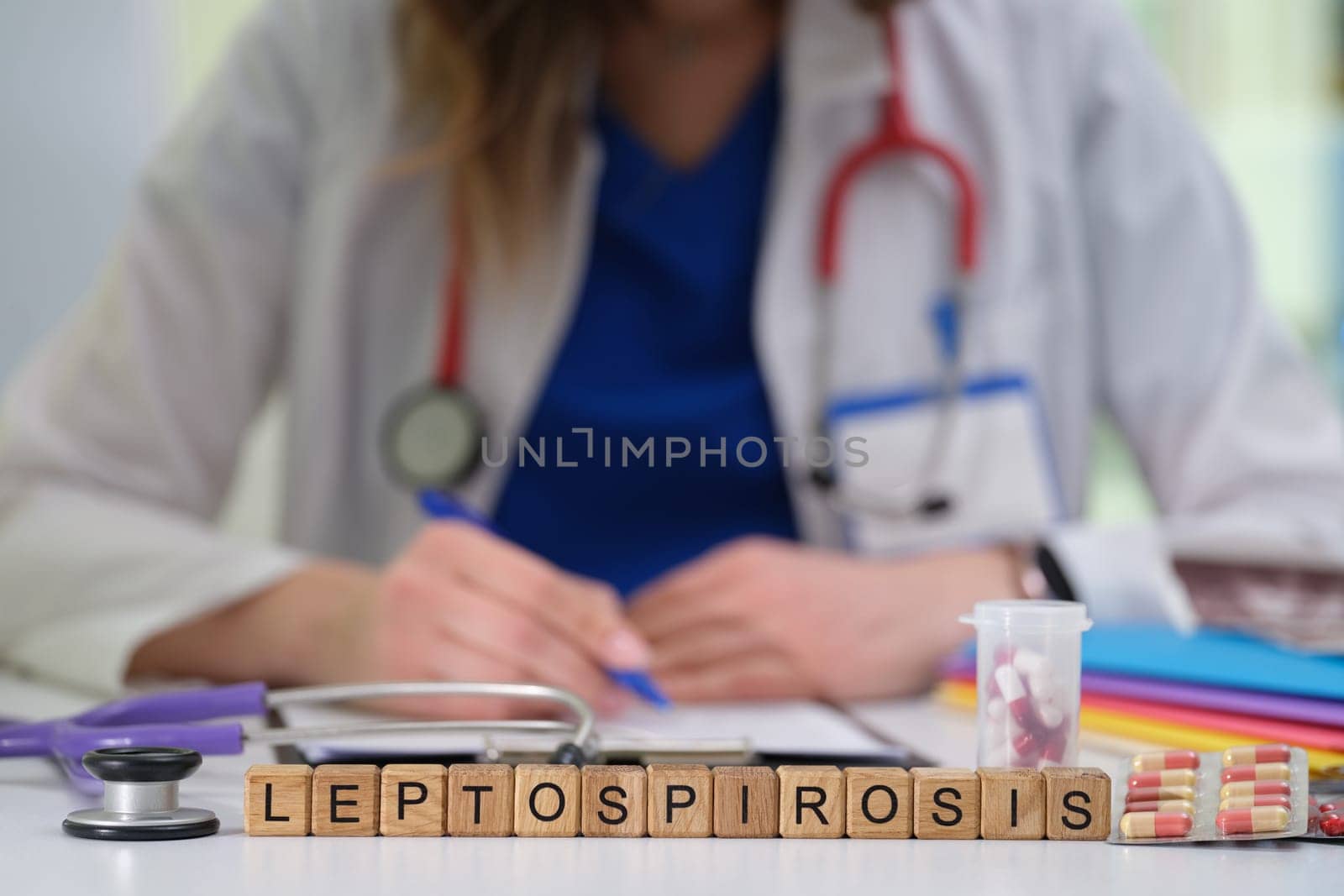 A dedicated healthcare professional is focused on diagnosing leptospirosis using medical tools and detailed notation
