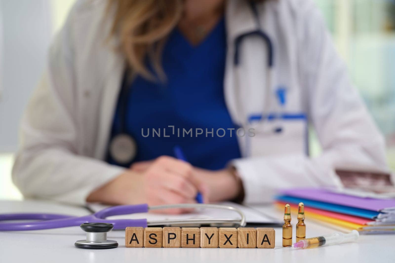 A qualified medical professional discusses asphyxia using various tools and taking notes in a clinical setting