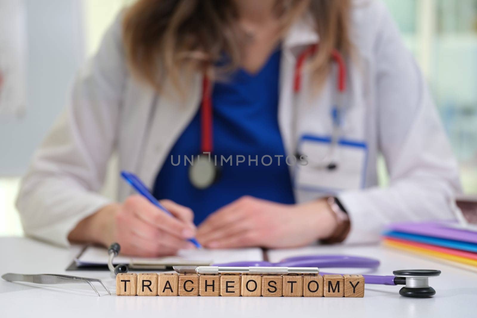A dedicated healthcare worker meticulously documents a complex tracheostomy procedure carried out in a clinical setting