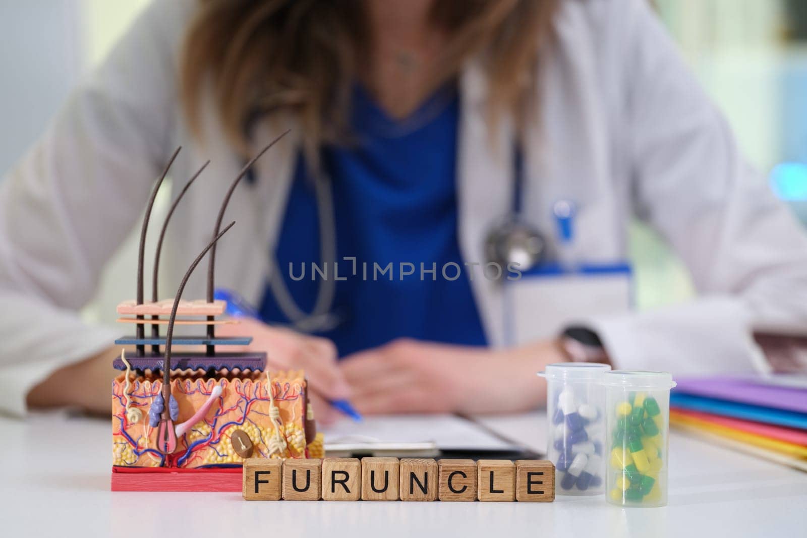 A detailed model illustrating a furuncle, with medical tools and a doctor's focus in the background.