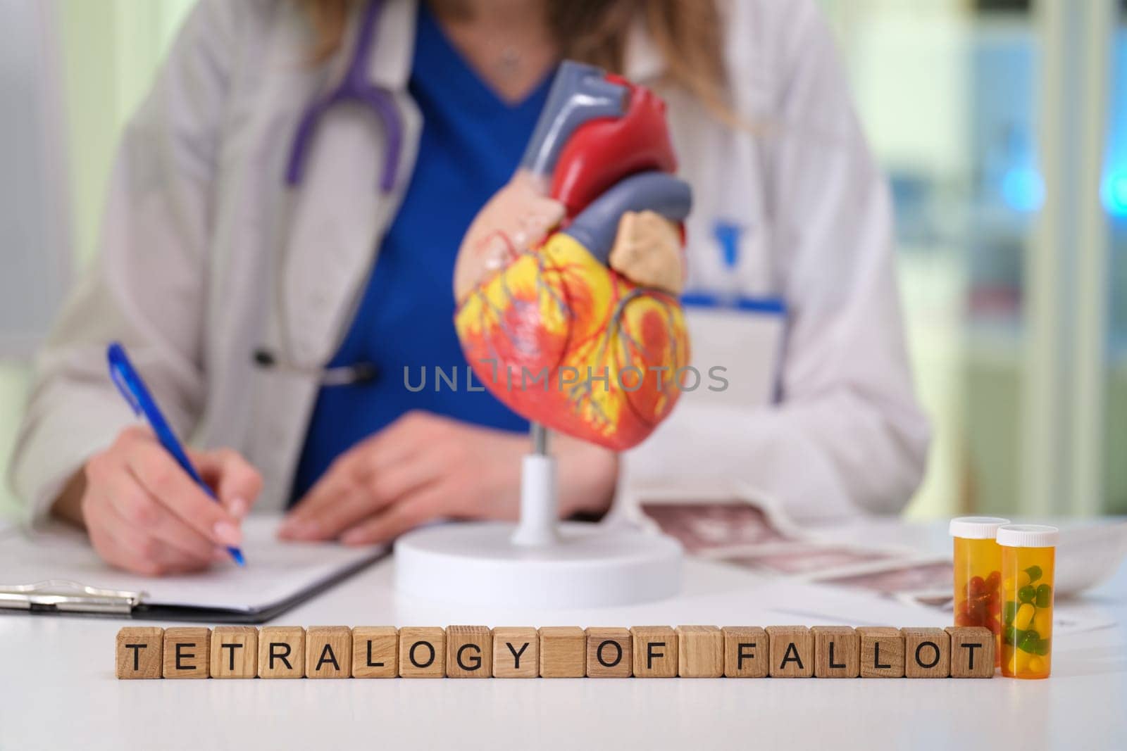 A medical professional discusses Tetralogy of Fallot using a heart model for clarity and understanding