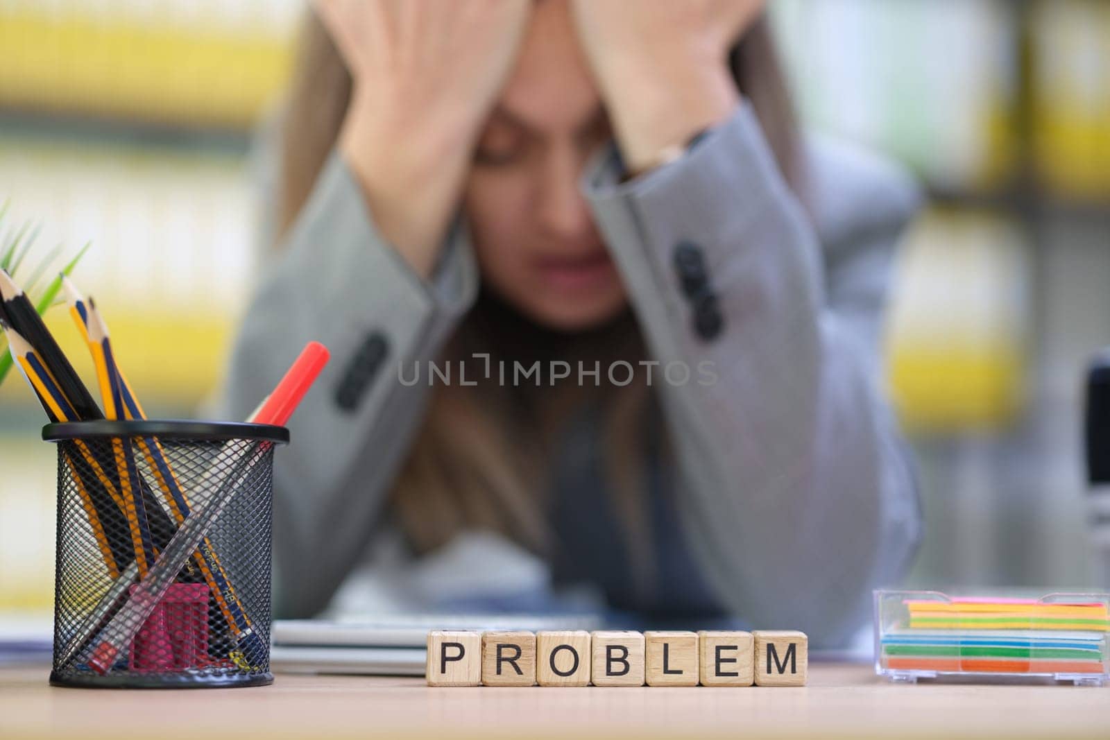 An employee appears visibly stressed while navigating and overcoming various challenges in a demanding work environment