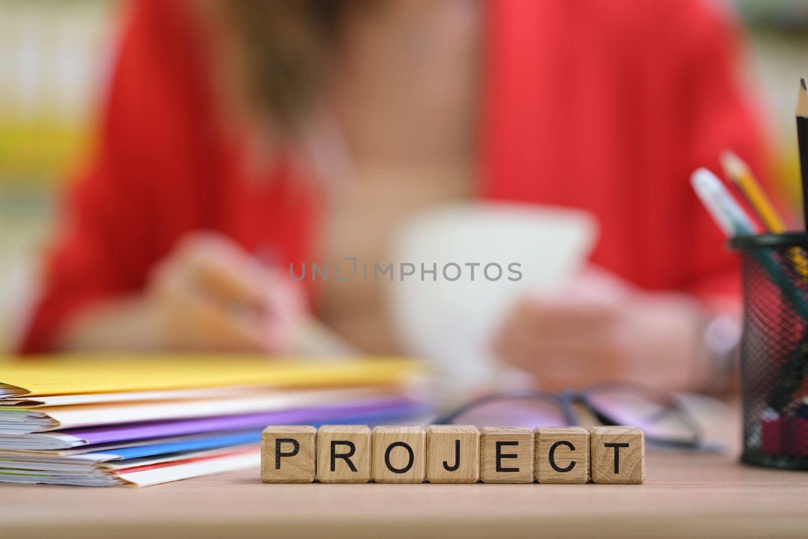 A lively workspace for a project, filled with colorful papers and a cheerful coffee cup that inspires creativity