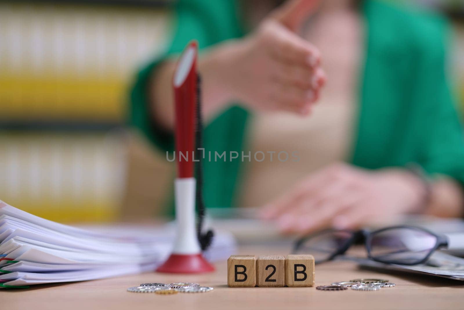 A professional environment that emphasizes B2B partnerships with important papers to sign and a firm handshake