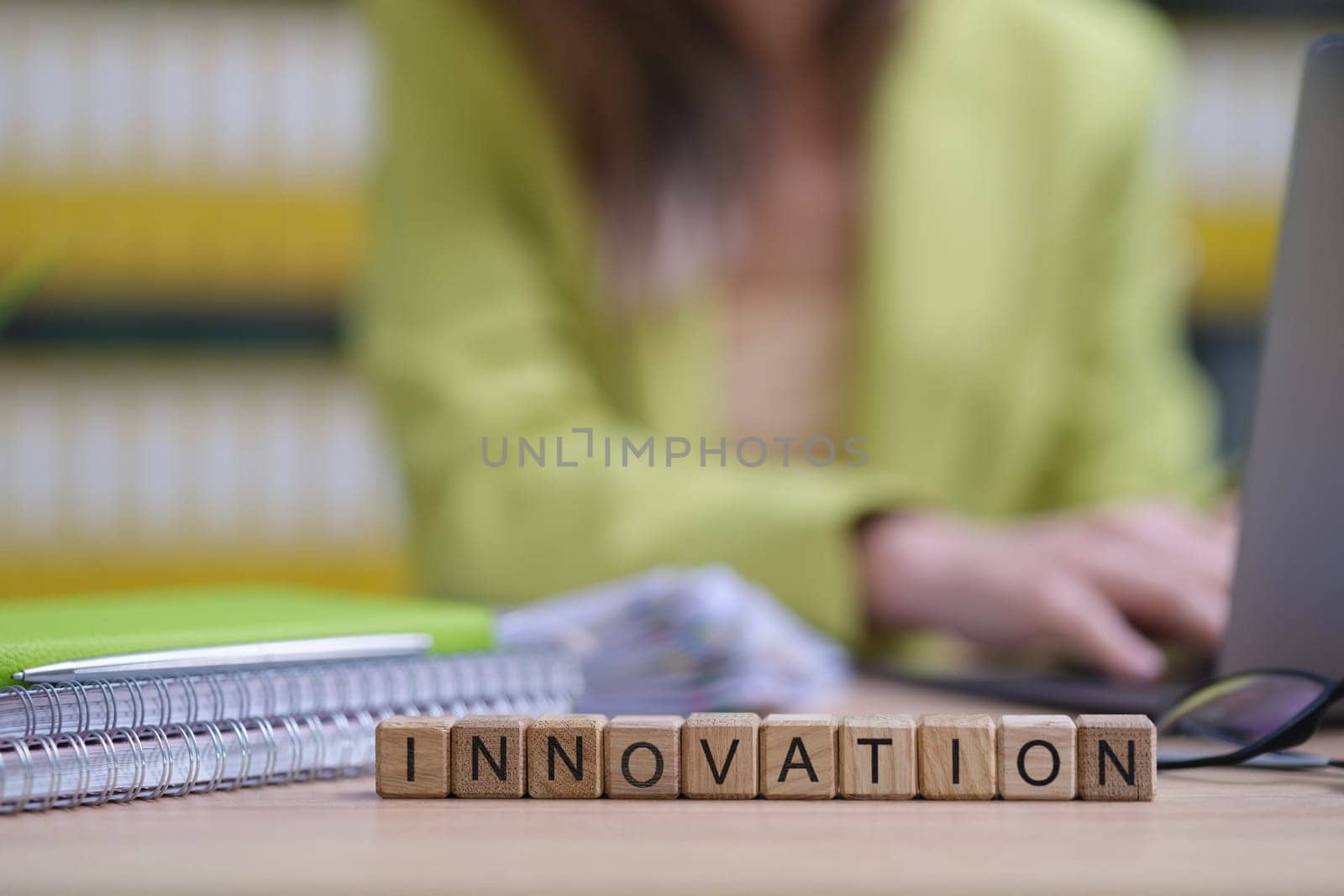 A closeup of a vibrant workspace shows blocks labeled INNOVATION, symbolizing creativity and progress