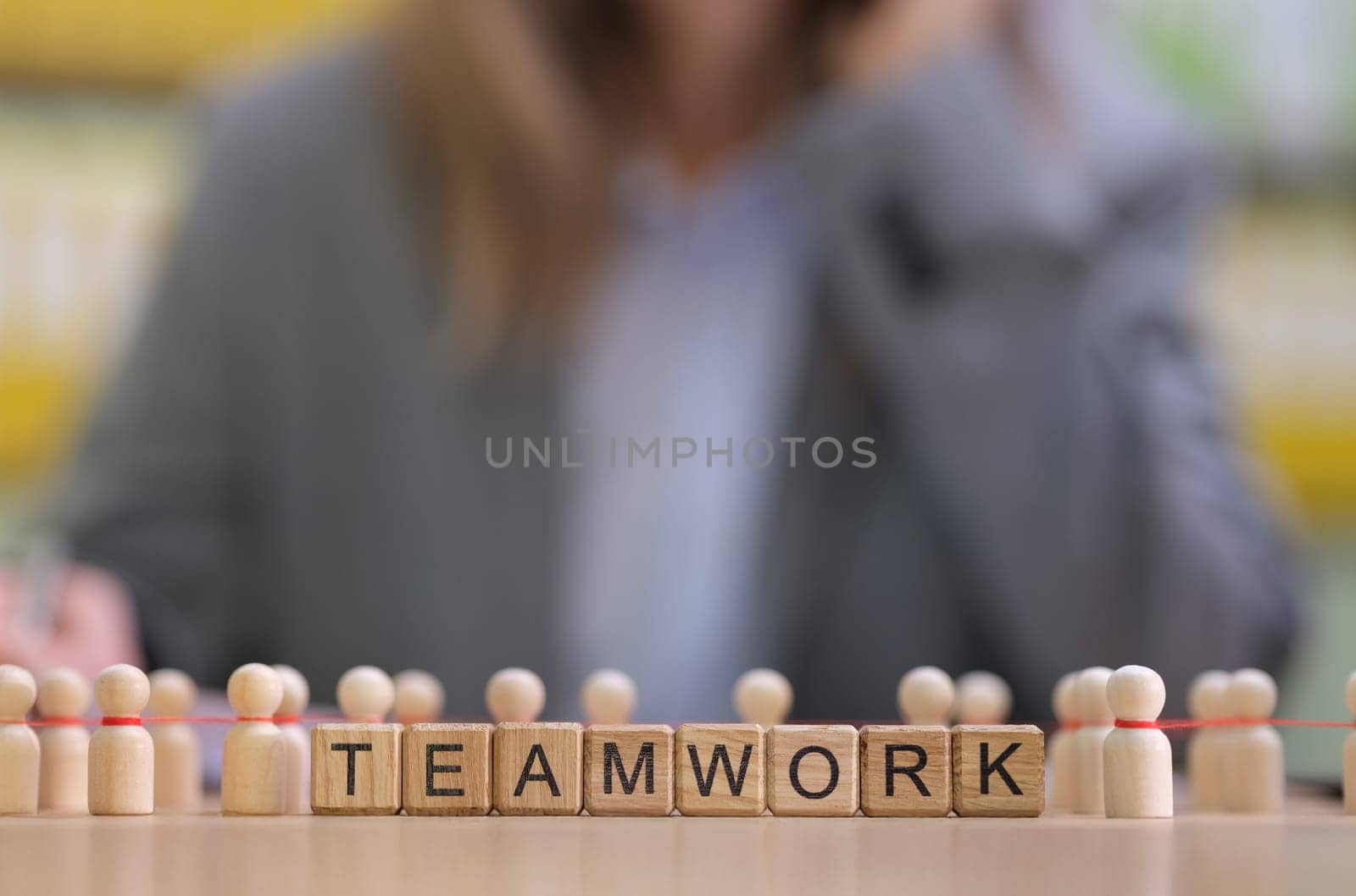This illustration highlights teamwork with blocks and mini figurines, promoting unity and connection