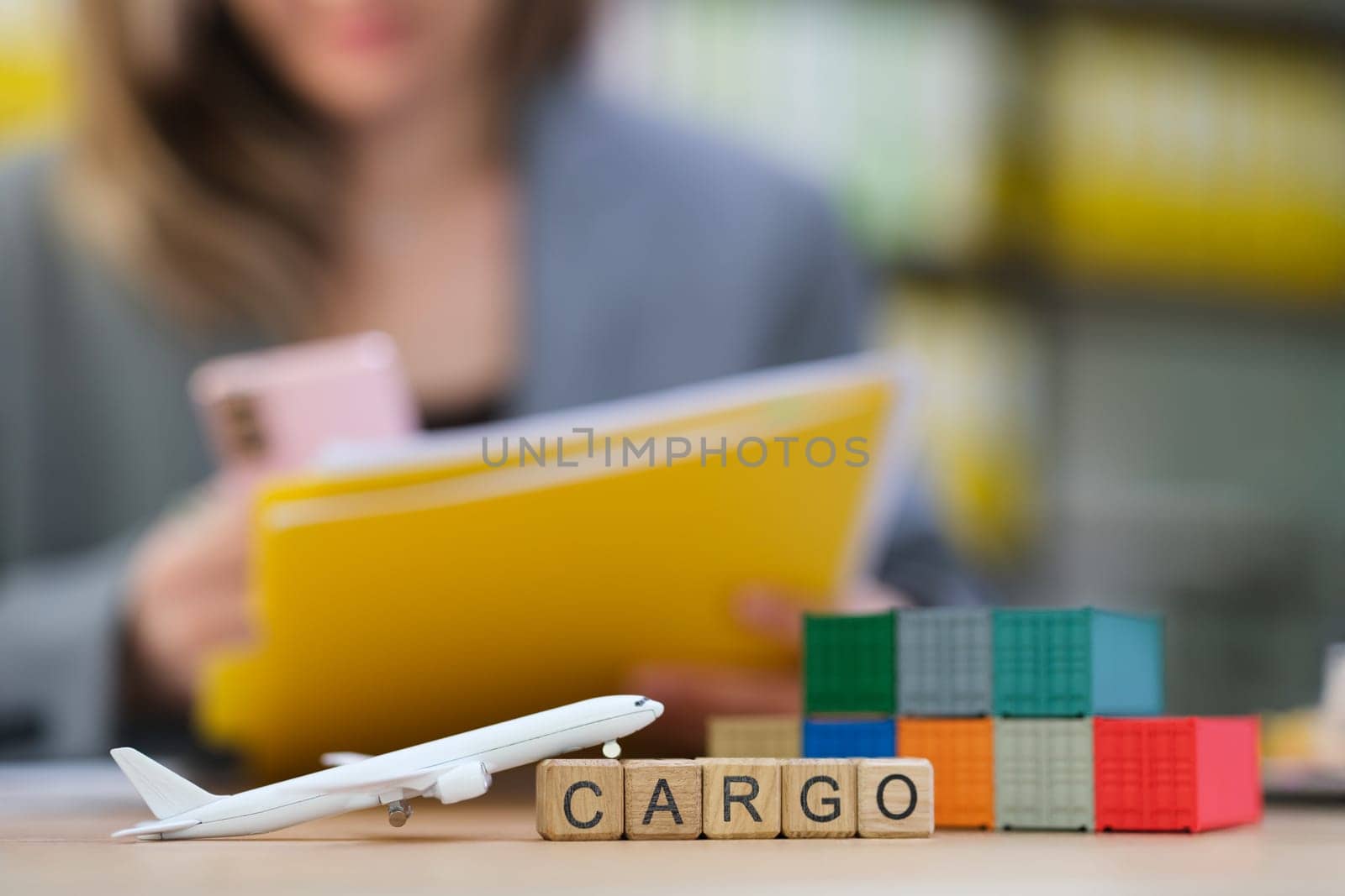 This is a professional air cargo logistics workspace featuring a model airplane alongside colorful building blocks