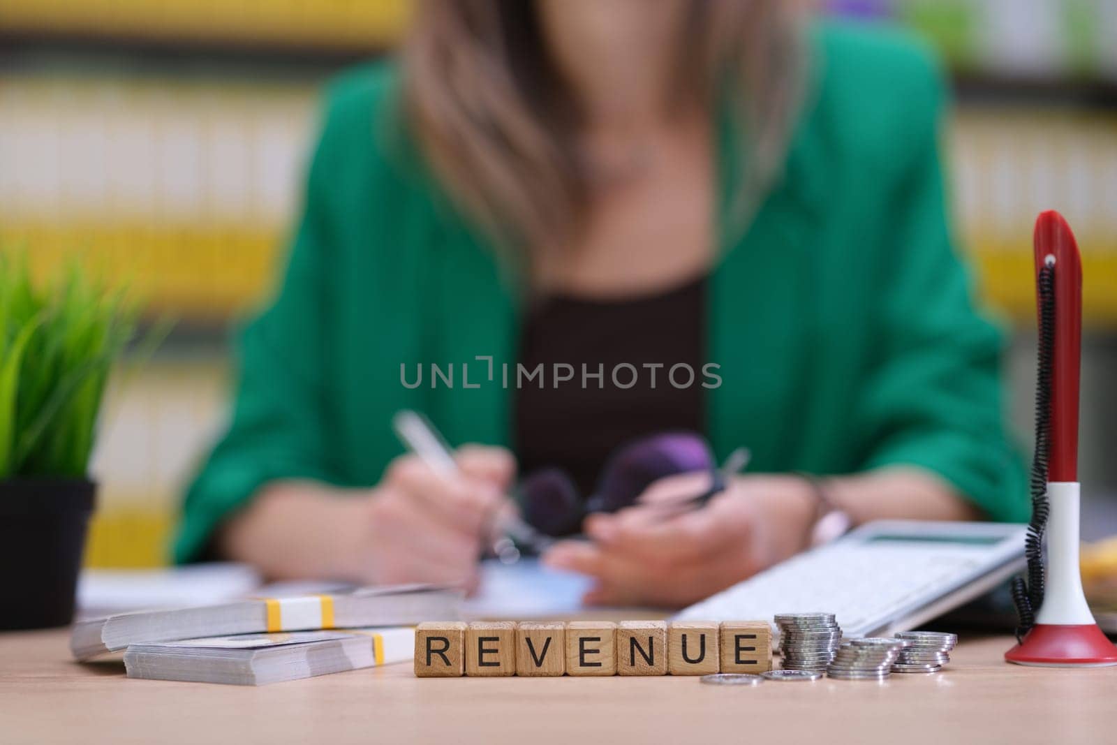 A highly skilled professional is analyzing revenue data using advanced tools in a modern office environment
