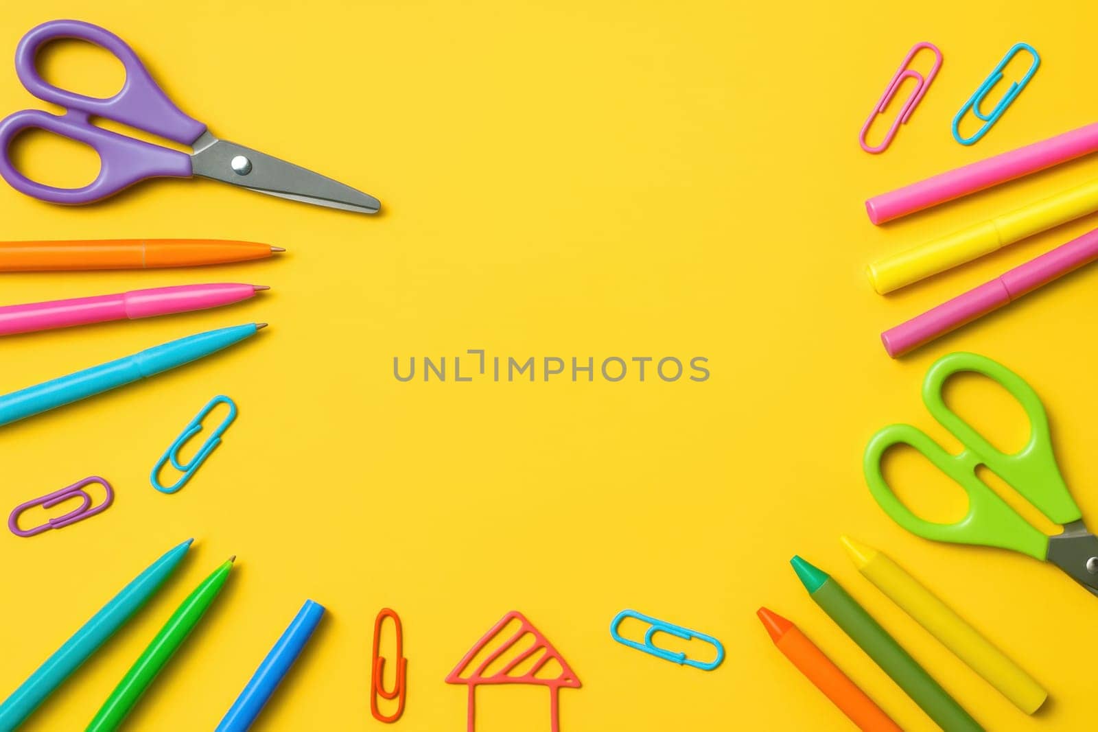 Vibrant flat lay with school and art supplies such as pens, crayons, scissors and clips on a bright yellow background. Perfect for educational promotions, creative projects or classroom visuals