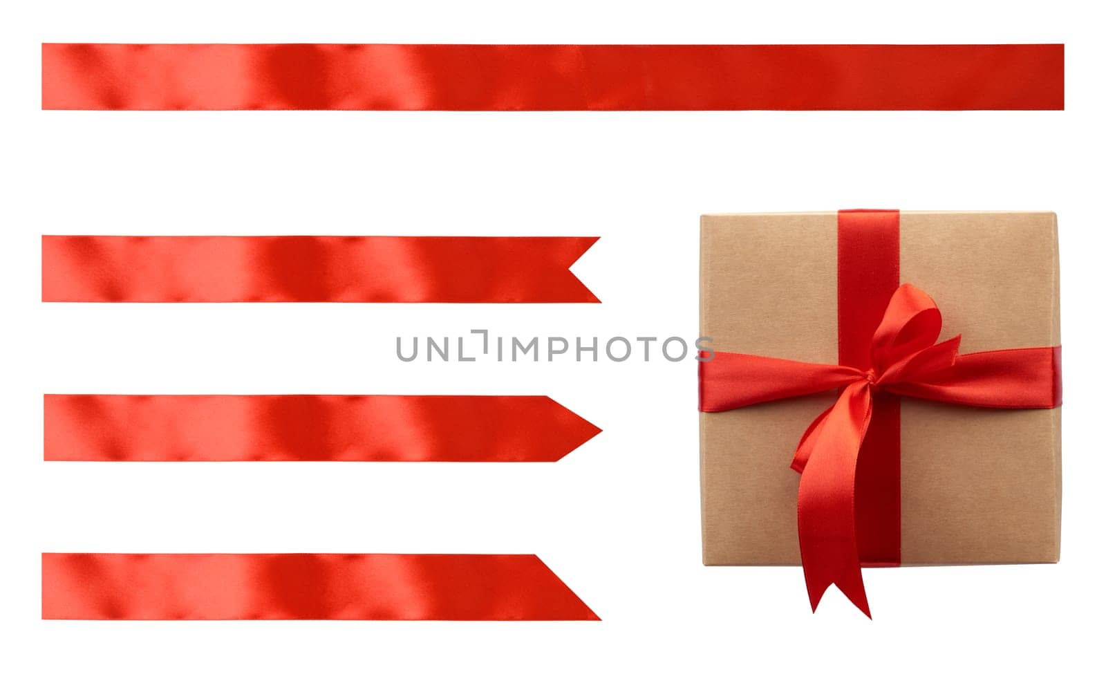 Kraft paper gift box tied with red satin ribbon with bow and set of red ribbons of different shapes on isolated background