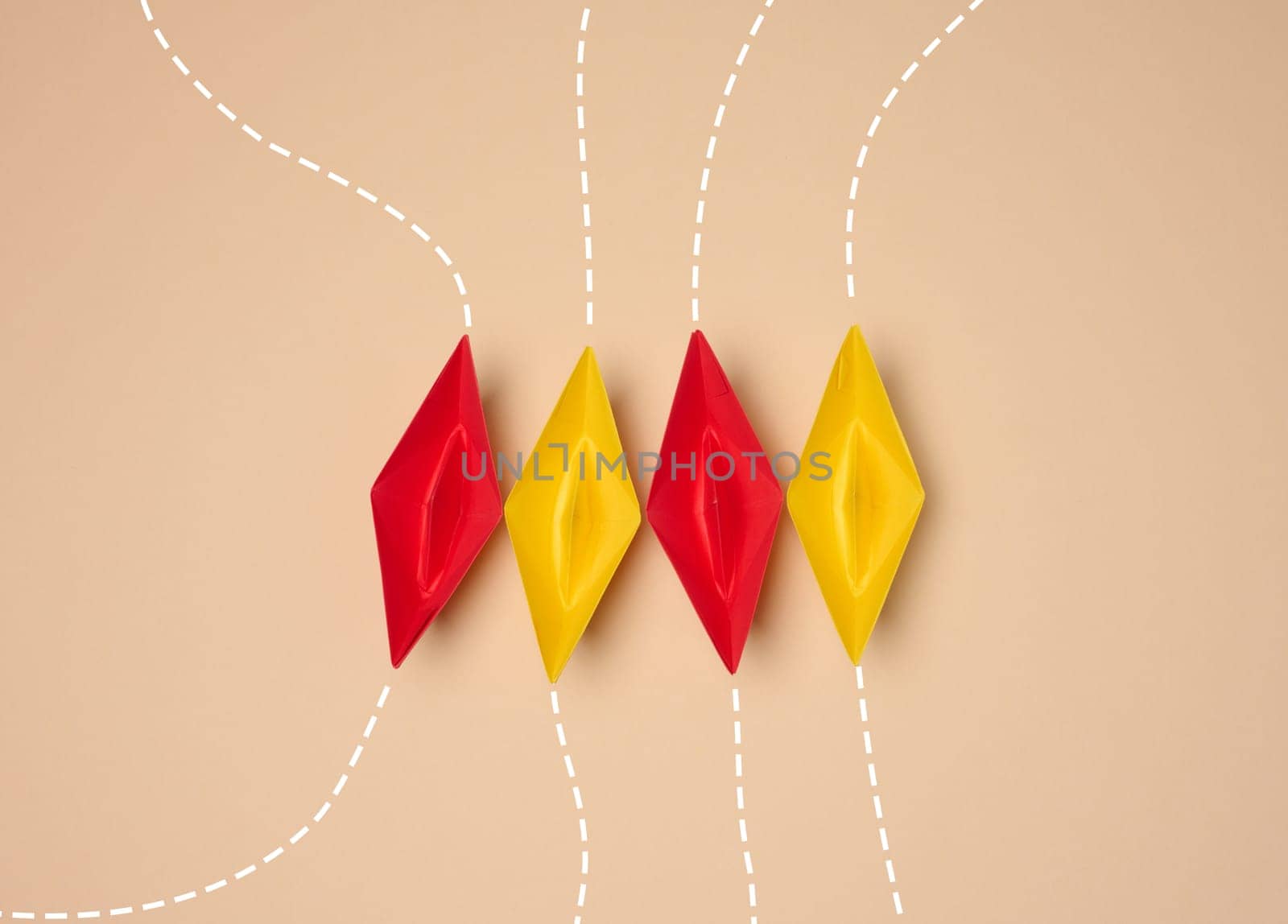 The dotted lines represent different paths leading to a group of red and yellow origami paper boats arranged in a row on a neutral background.