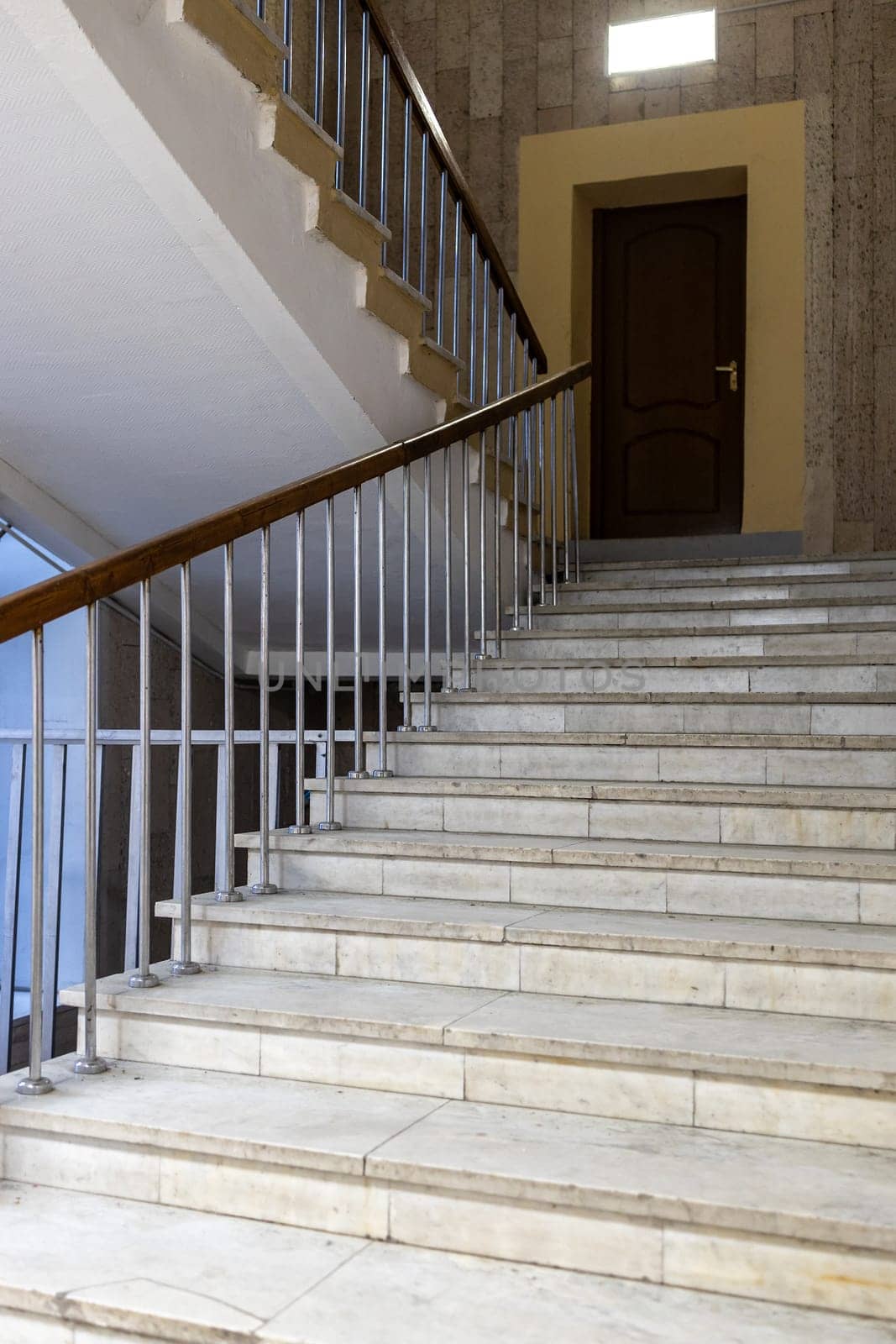 marble stairs between floors in entrance of building