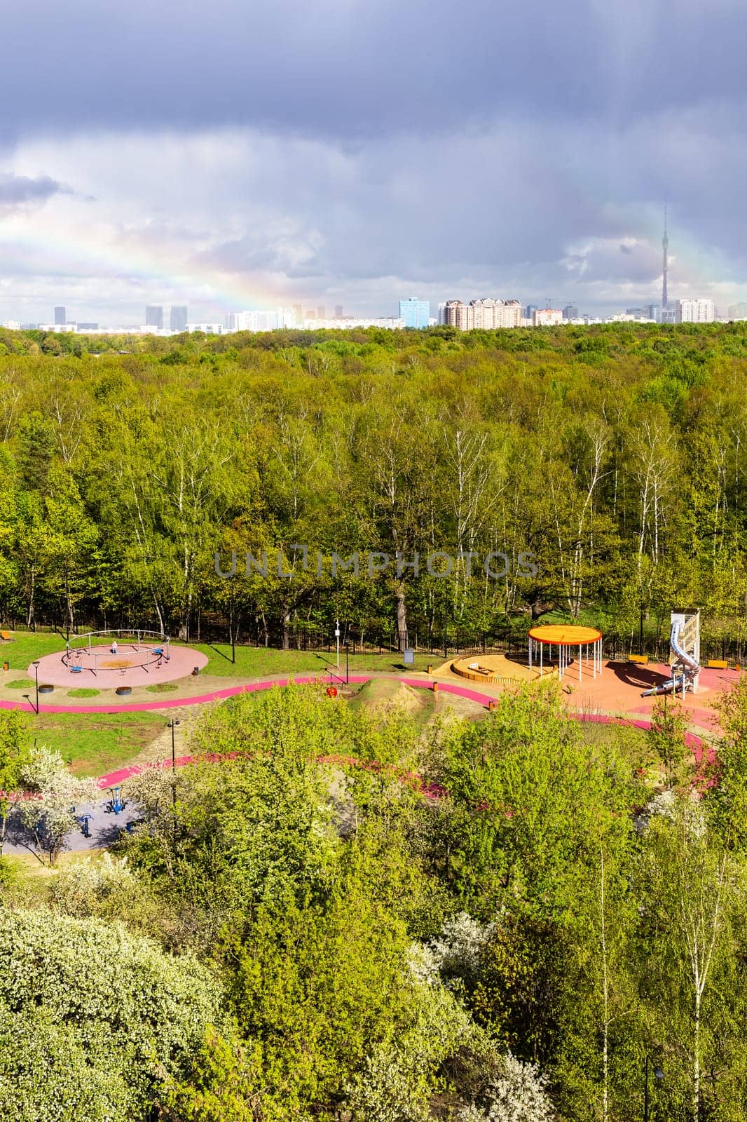 sunlit playground near city park after rain on sunny spring day