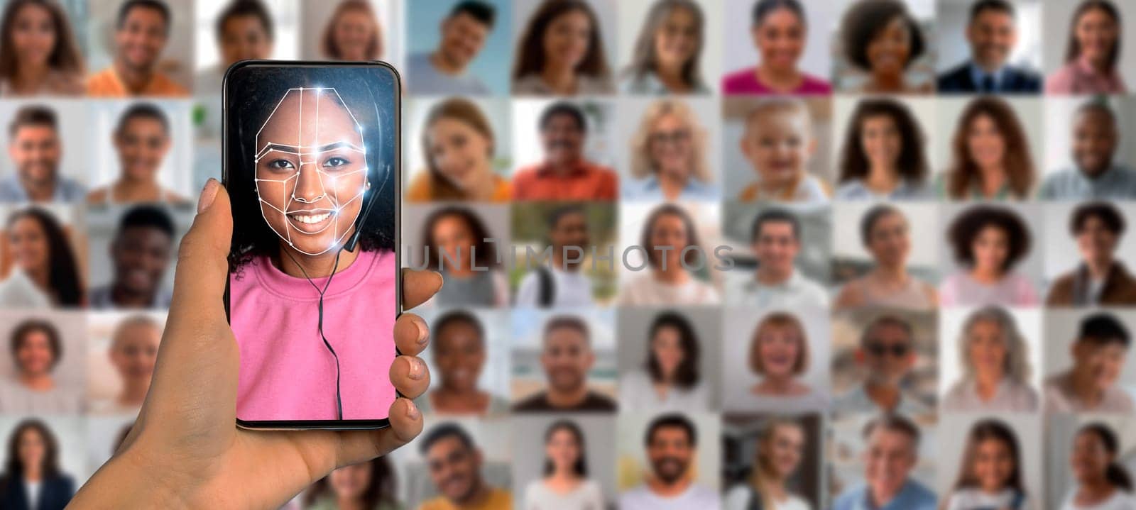 A hand holds a smartphone showcasing facial recognition technology with a smiling person on the screen.