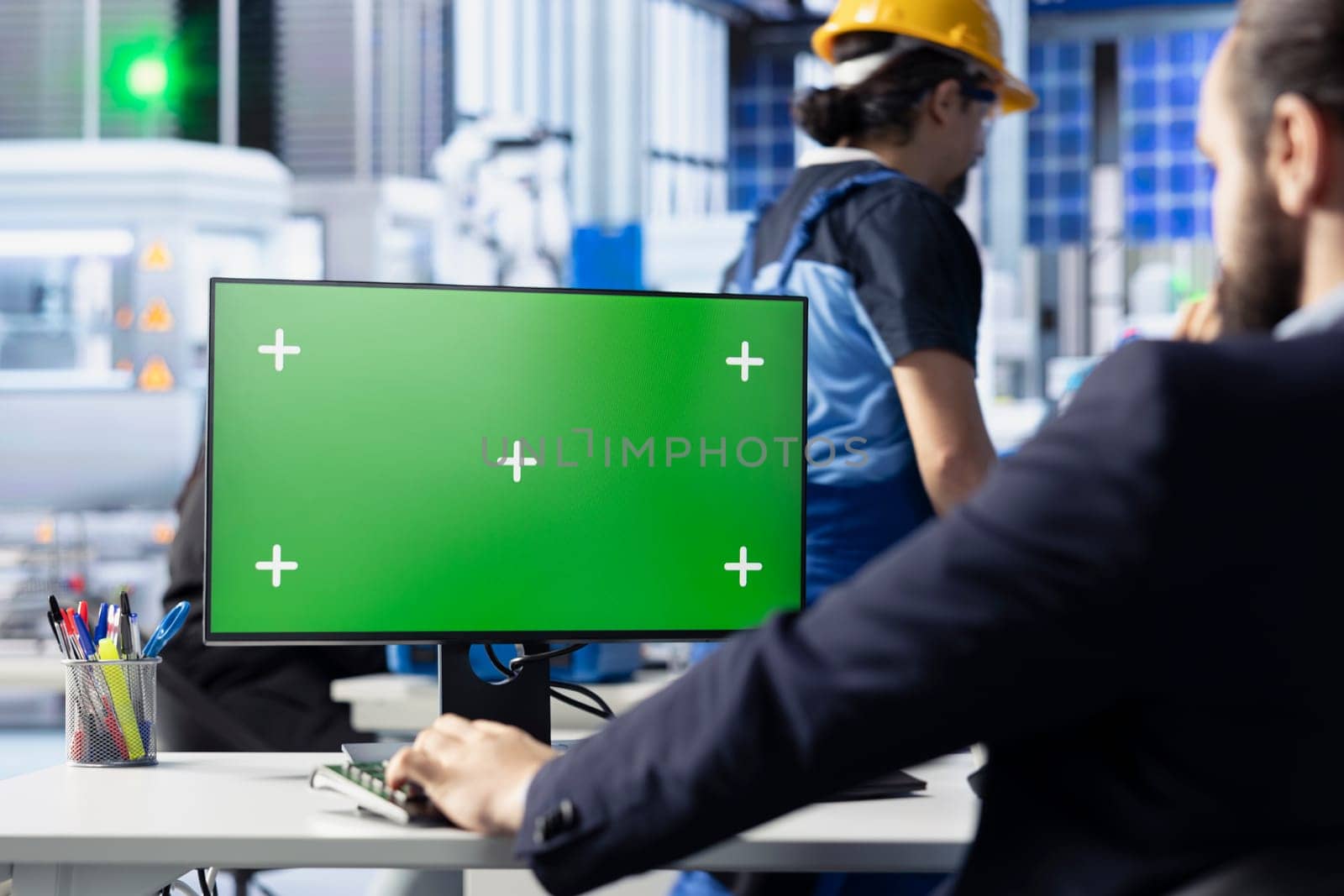 Engineer in photovoltaics factory reviewing system logs on green screen computer to identify operational inefficiencies. Photovoltaic plant worker adjusting manufacturing parameters on chroma key PC