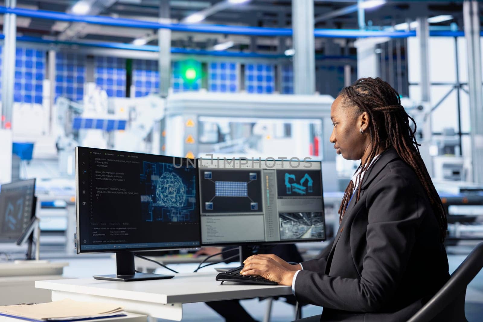 Engineer coding in solar panel plant, using artificial intelligence to automate equipment processes. Photovoltaics factory programmer writing scripts to optimize robotic operations using AI tech