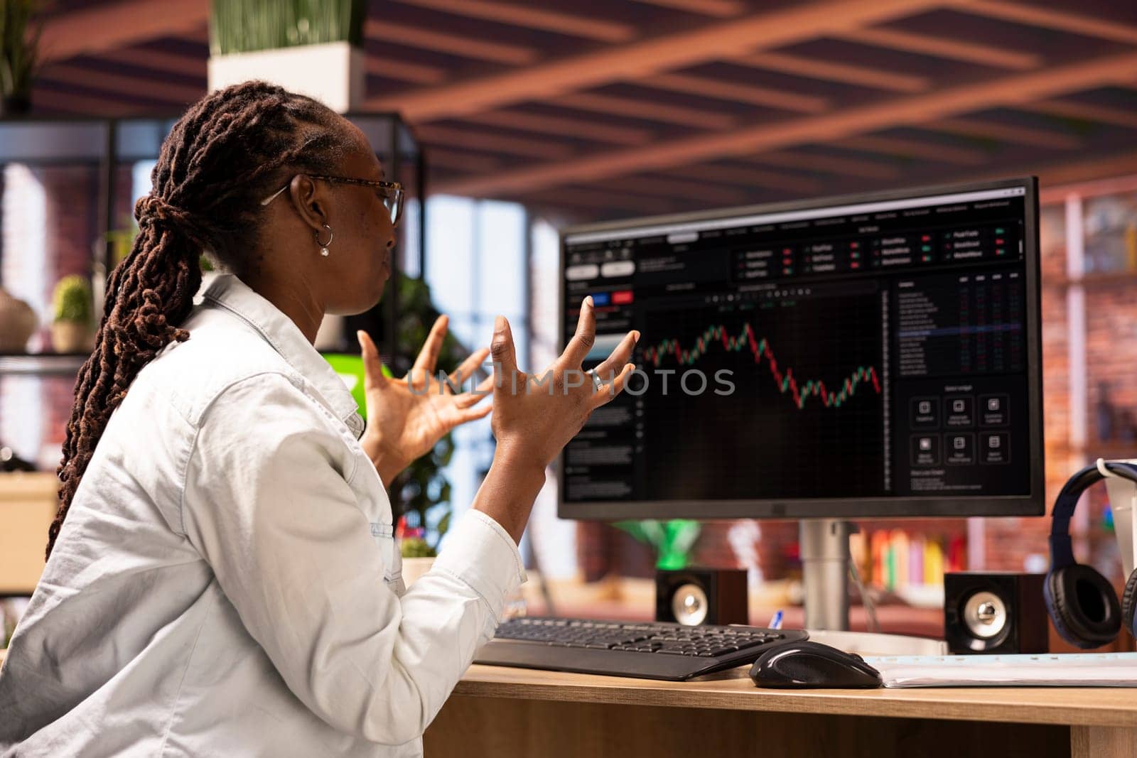 Frustrated day trader feeling upset, looking at PC display, showing falling stock prices, red charts and losses. Investor overwhelmed while looking at drop in stock exchange shares on monitor