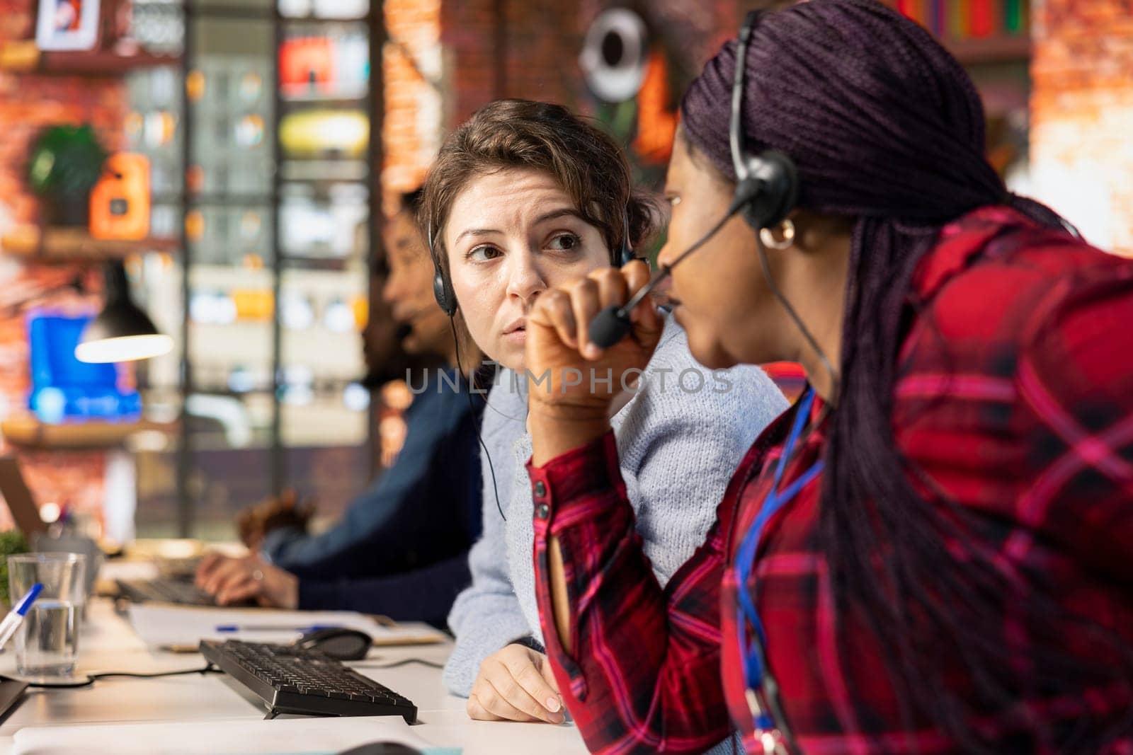 Call center colleagues doing brainstorming, using remote access tools to connect to customer devices, fixing errors. Customer center coworkers cooperating, assisting clients with installing software