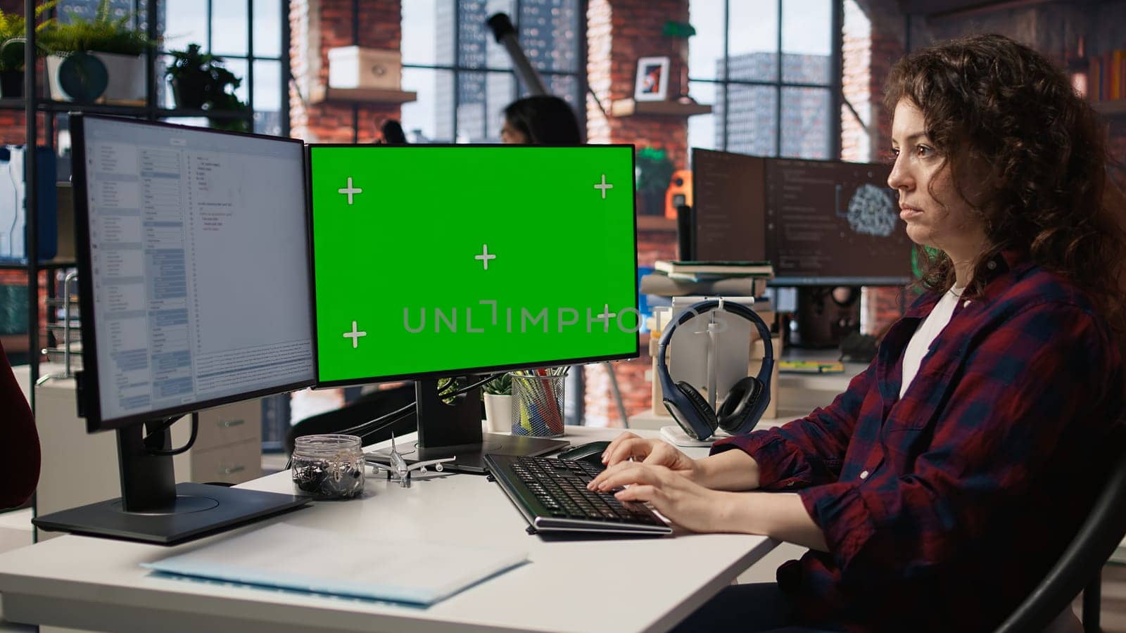 Woman coding in AI startup office using mockup PC, building scalable solutions for businesses. AI industry startup technician leveraging machine learning technology on green screen computer, camera A