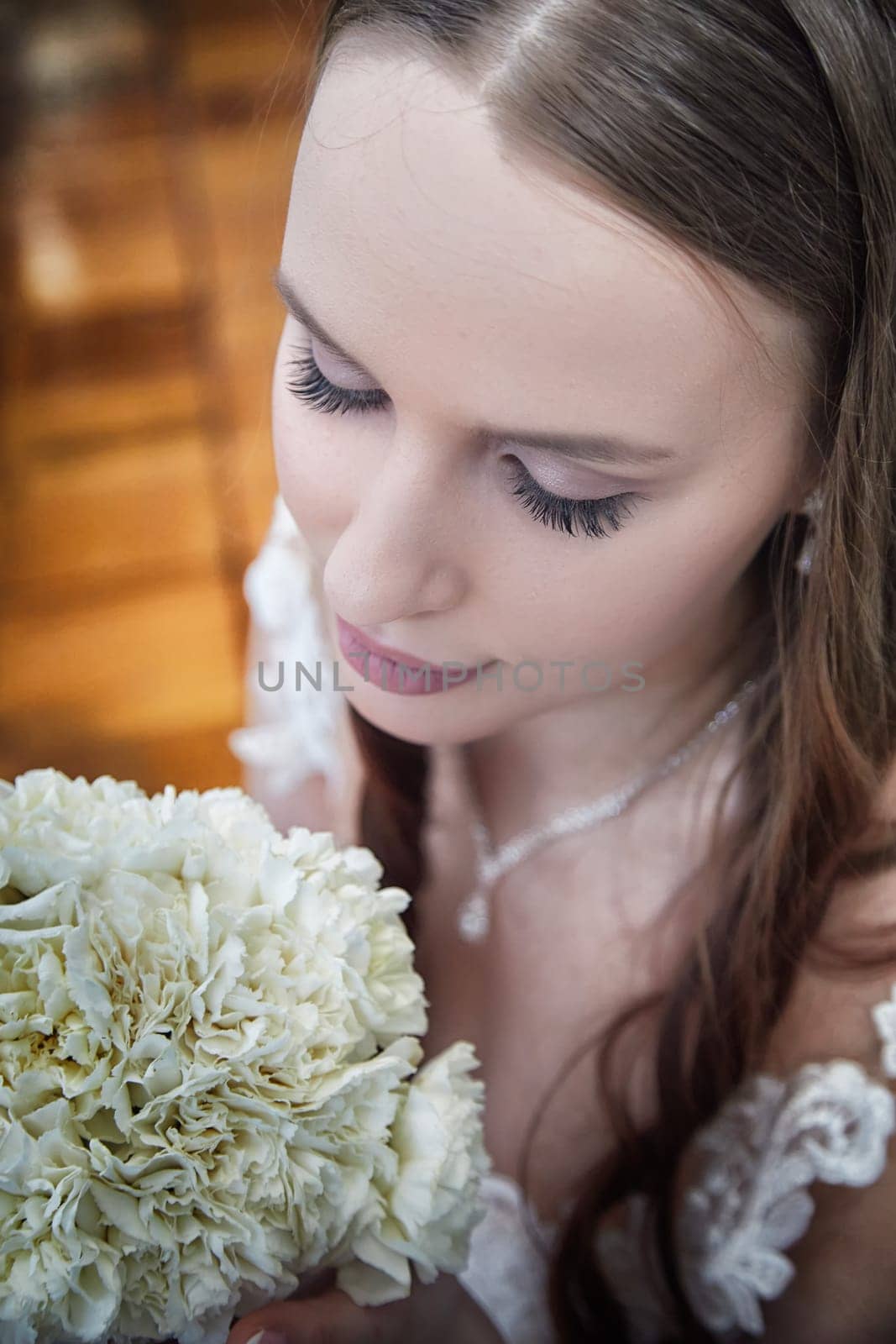 Bride holds a beautiful bouquet close while reflecting on her special day with the groom during their wedding registration.