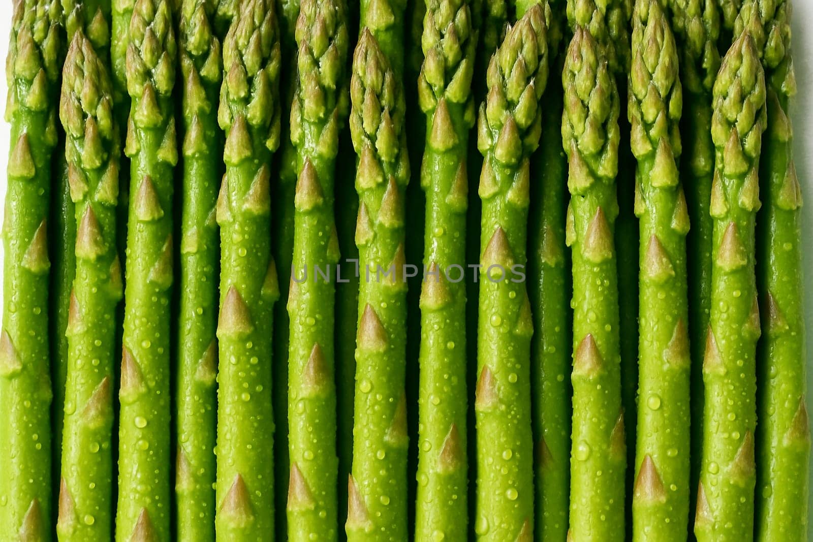 AI generated top view of fresh asparagus with water droplets in bright daylight showing vibrant color and freshness suitable for food and organic concept