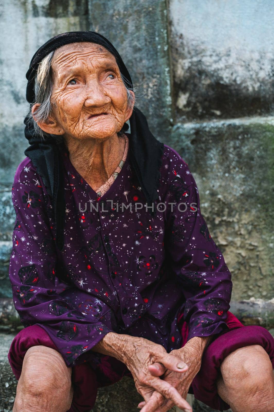 Portrait of a sad beggar old elderly Asian Vietnamese woman in a village in Asia in Vietnam. Tam Thanh, Quang Nam province, Vietnam - April 10, 2025