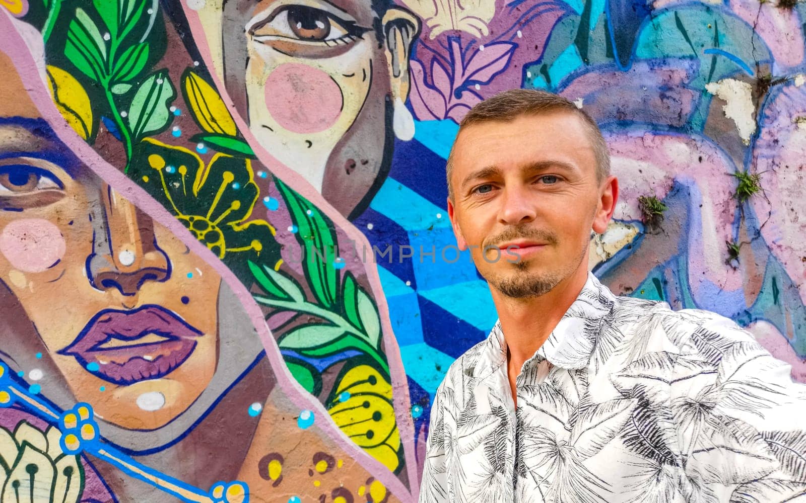 Handsome Man Tourist with Santa Teresa Centro City Street Streets Cityscape Panorama with Tourism Art Graffiti Paintings and Buildings in Brazil.