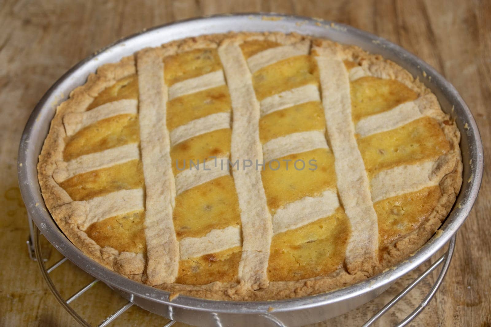A delicious homemade jam tart with a golden, flaky crust and a glossy fruit filling, showcasing its rustic charm and inviting sweetness