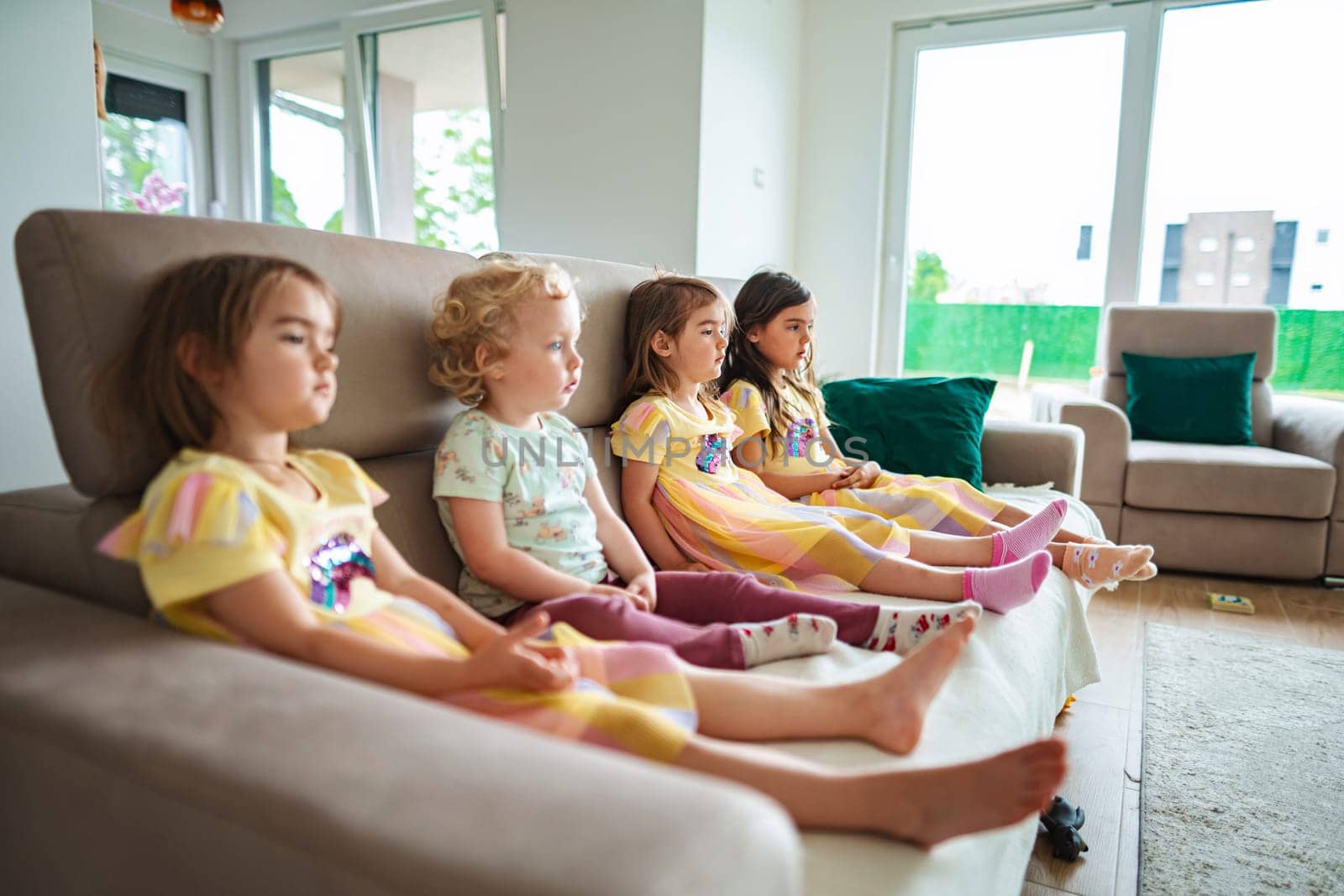 Four kids enjoy quiet time in a sunny setting.