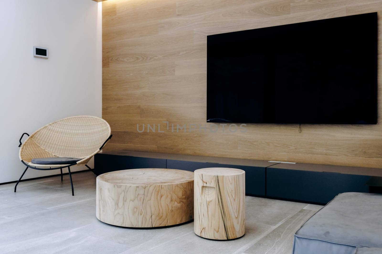 Imagine a cozy living room featuring two beautifully crafted wooden tables, along with a sleek flat screen television mounted stylishly on the wall