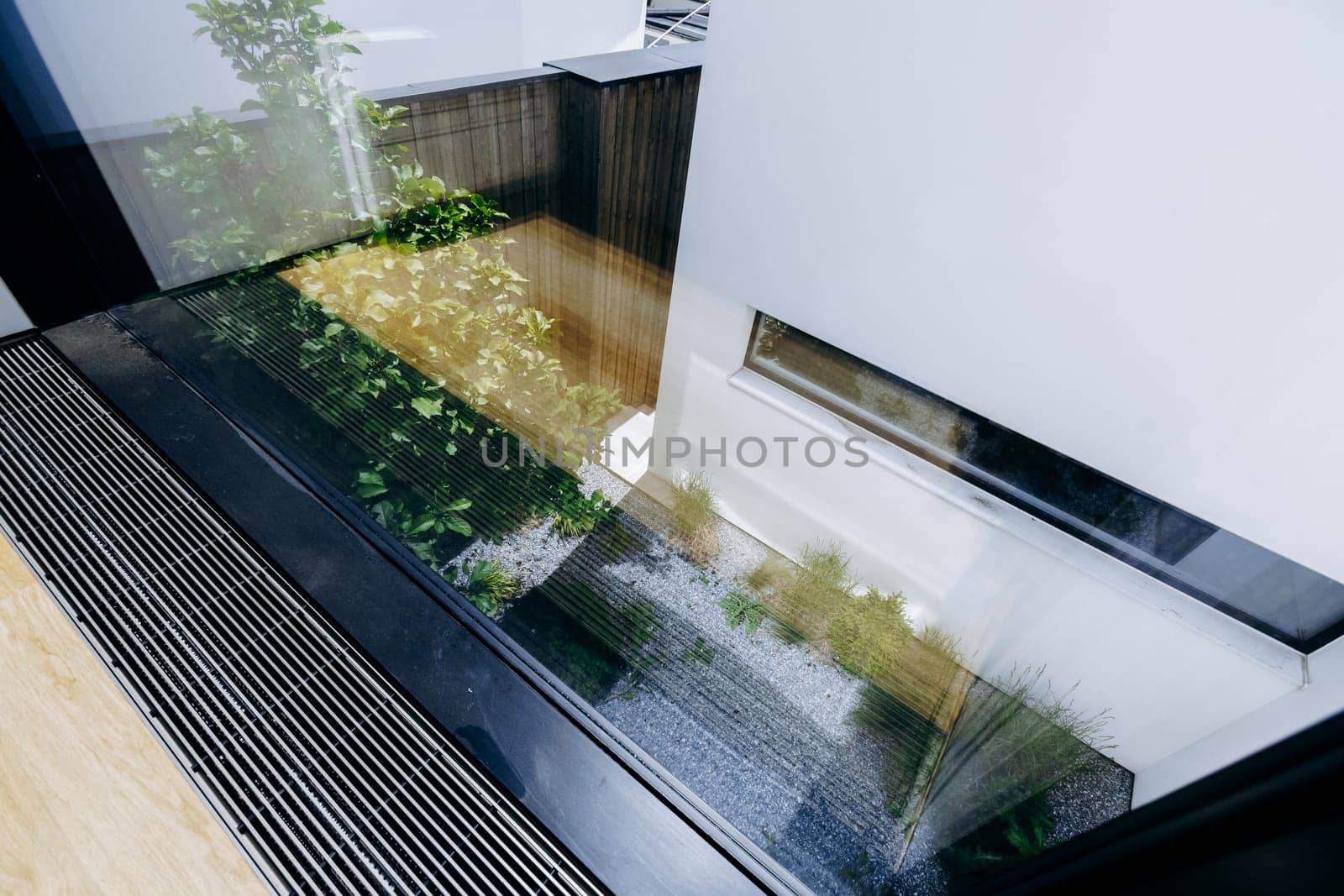 This is an observation of how a buildings image is captured in the gleaming surface of a glass window nearby