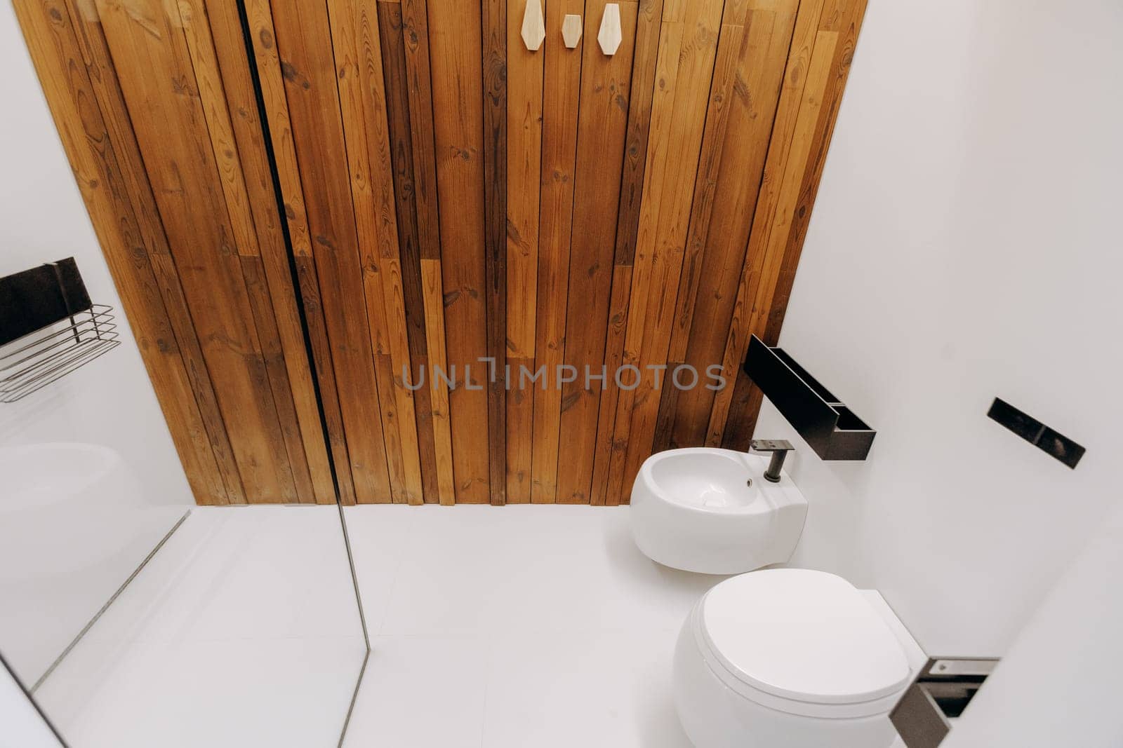 A bathroom equipped with essential amenities including a toilet, a sink for washing hands, and a mirror for grooming purposes