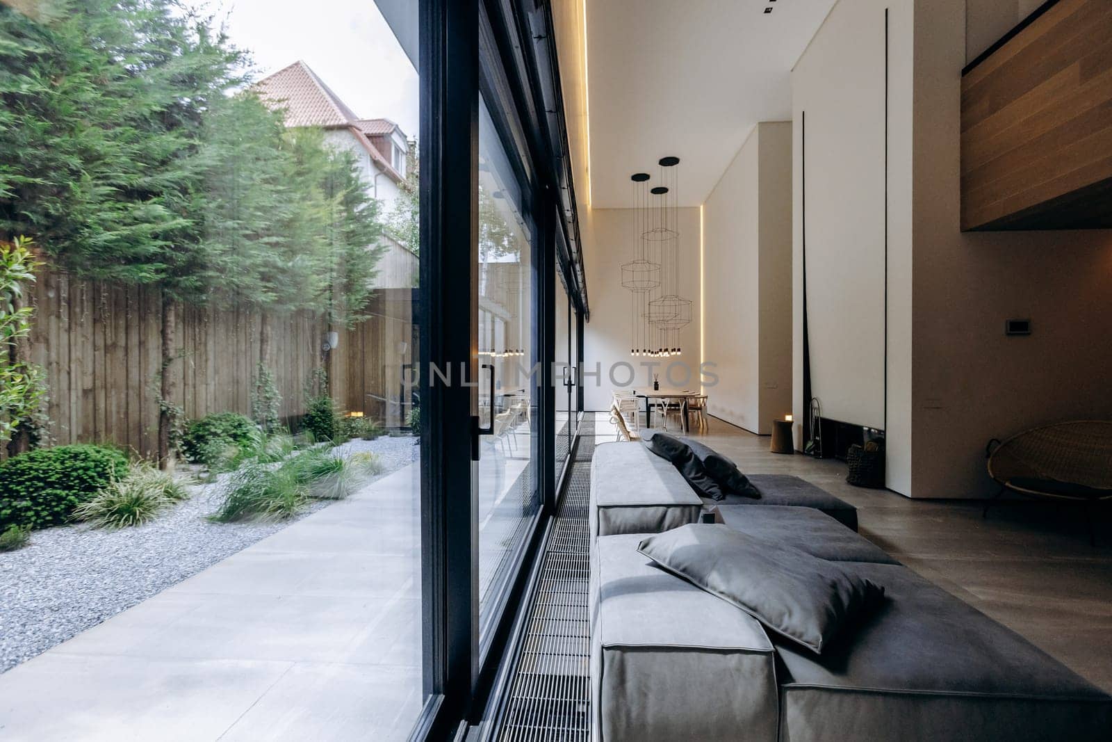 This is a lovely living room, featuring an abundance of windows that let in natural light, complete with a cozy couch for relaxation