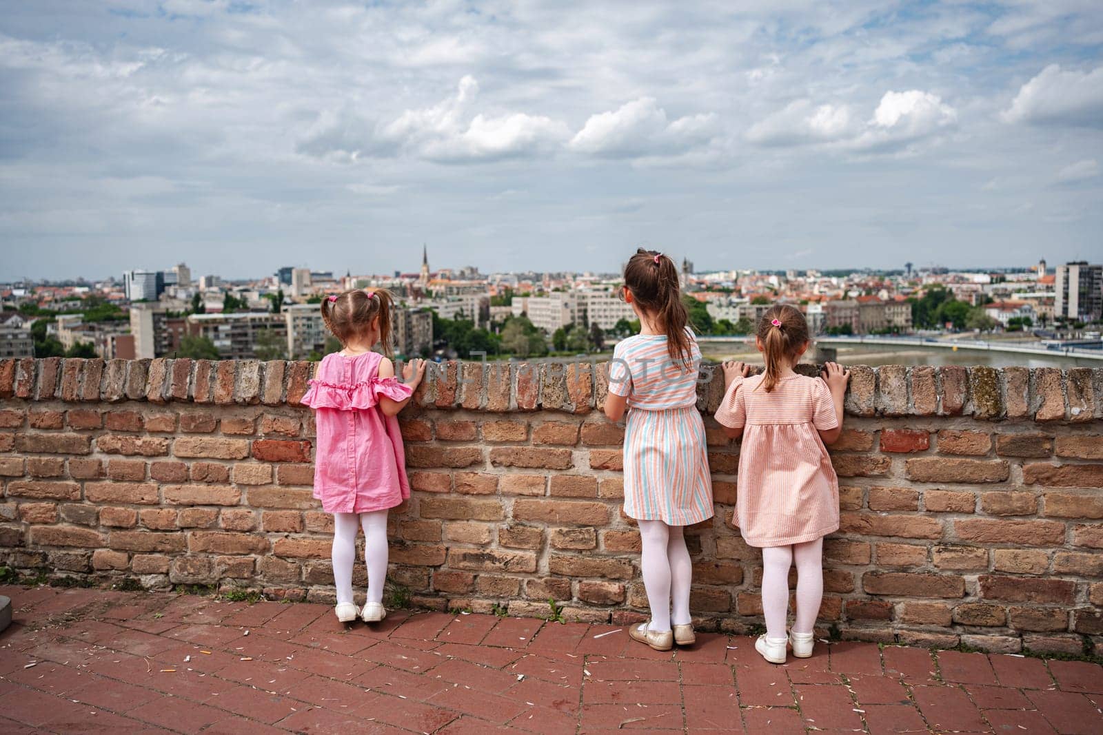 Young girls admire the panoramic skyline of Novi Sad.