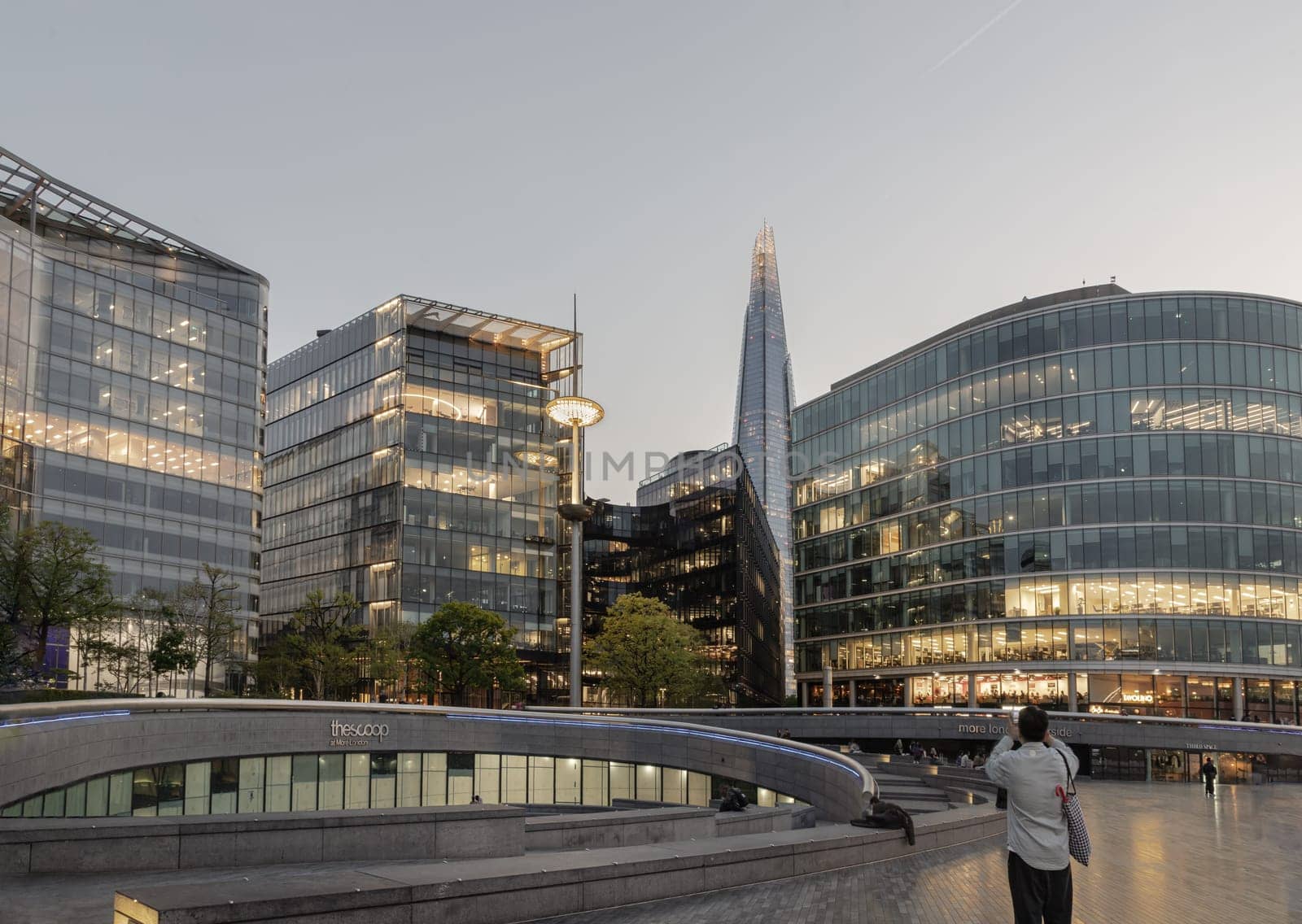London, UK - Apr 27, 2025 - The scoop, an amphitheatre next to the GLC building, at More London with the Shard and other Modern glass buildings behind. The Stunning view after sunset in City of London. use it as your Wallpaper, Poster and Copy space. Selective focus.