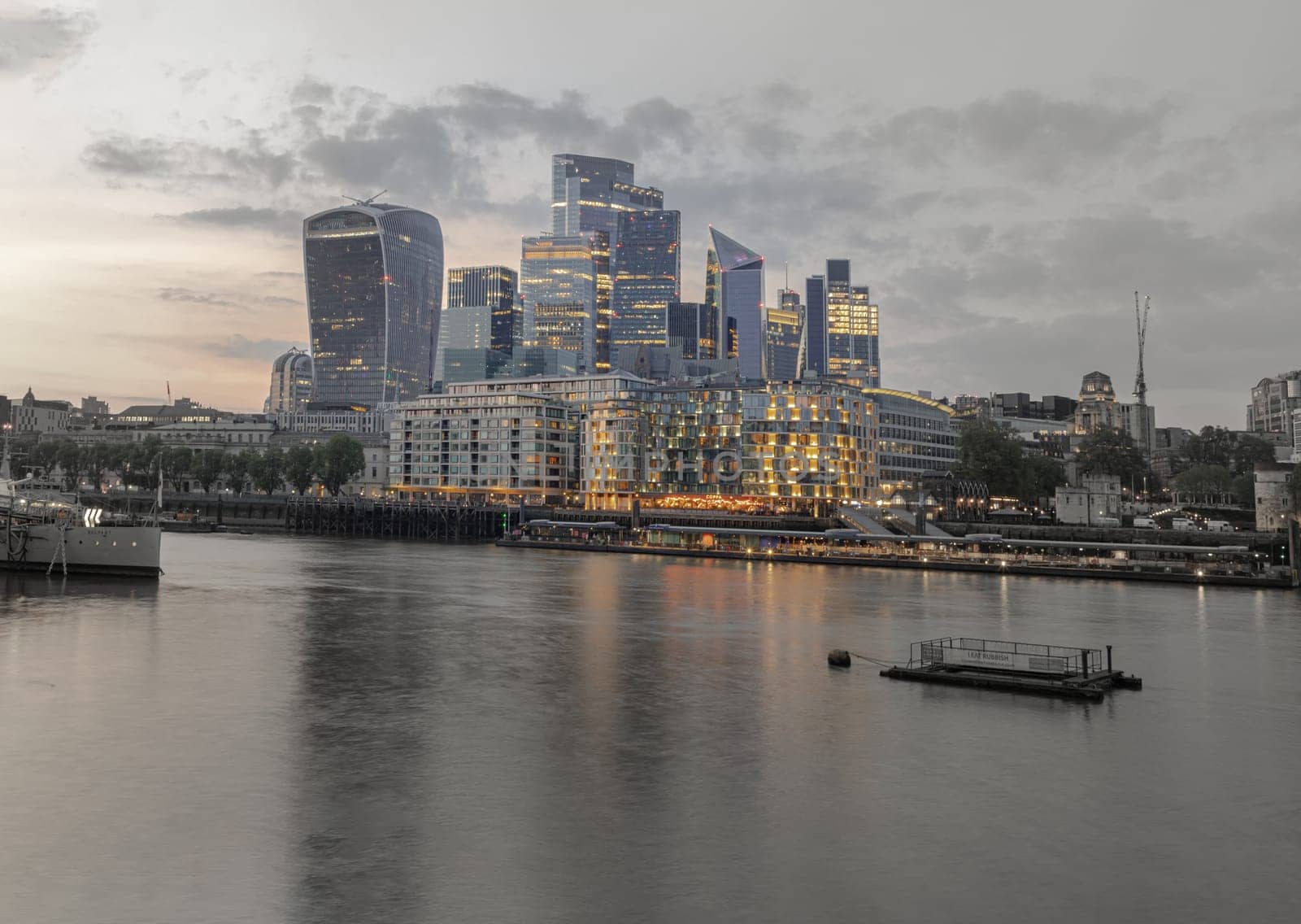 London, UK - Apr 27, 2025 - The Stunning view of The Skyscrapers of Financial District with River Thames after sunset in City of London. use it as your Wallpaper, Poster and Space for text. Selective focus.