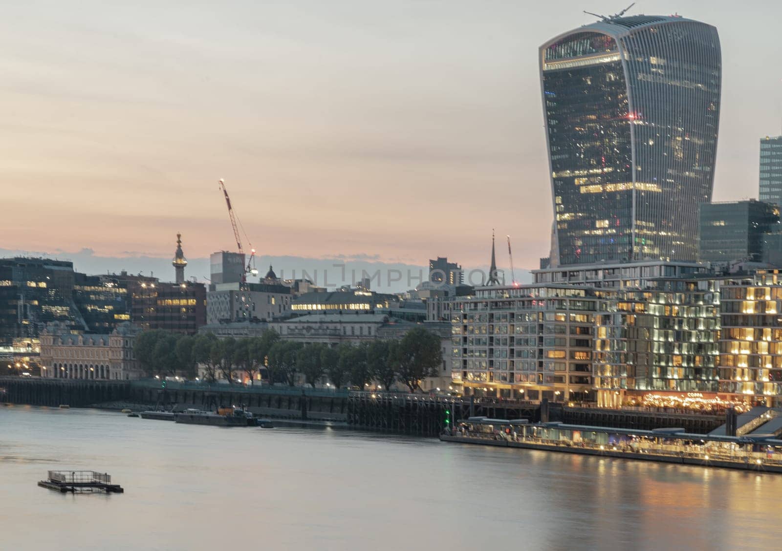London, UK - Apr 27, 2025 - The Stunning view of The modern 20 Fenchurch Street (Walkie-Talkie building) and River Thames after sunset in City of London. use it as your Wallpaper, Poster and Space for text. Selective focus.