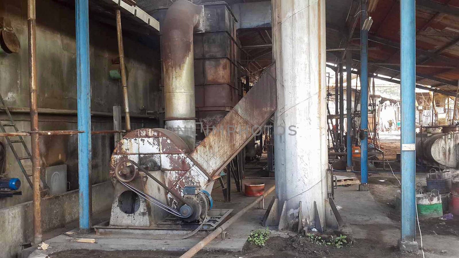 plywood processing plant showcasing Industrial Warehouse Interior with Stacks of Materials and Machinery, warehouse featuring industrial equipment, materials, and wooden pallets, highlighting productivity and organization.