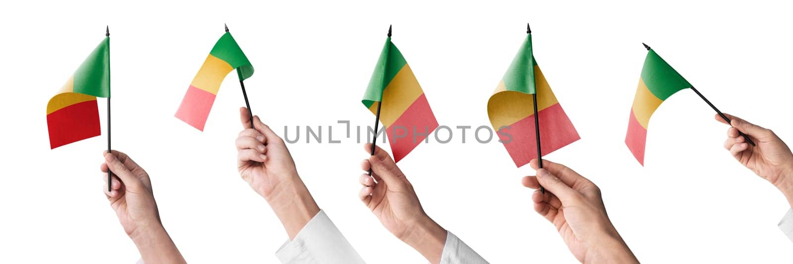 The Mali flag in hand in different angles on a white background.