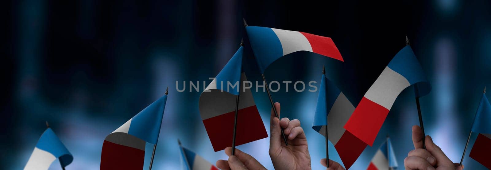 France flags in their hands on a blurred urban background. The photo illustration was created without the use of artificial intelligence, only using Photoshop.