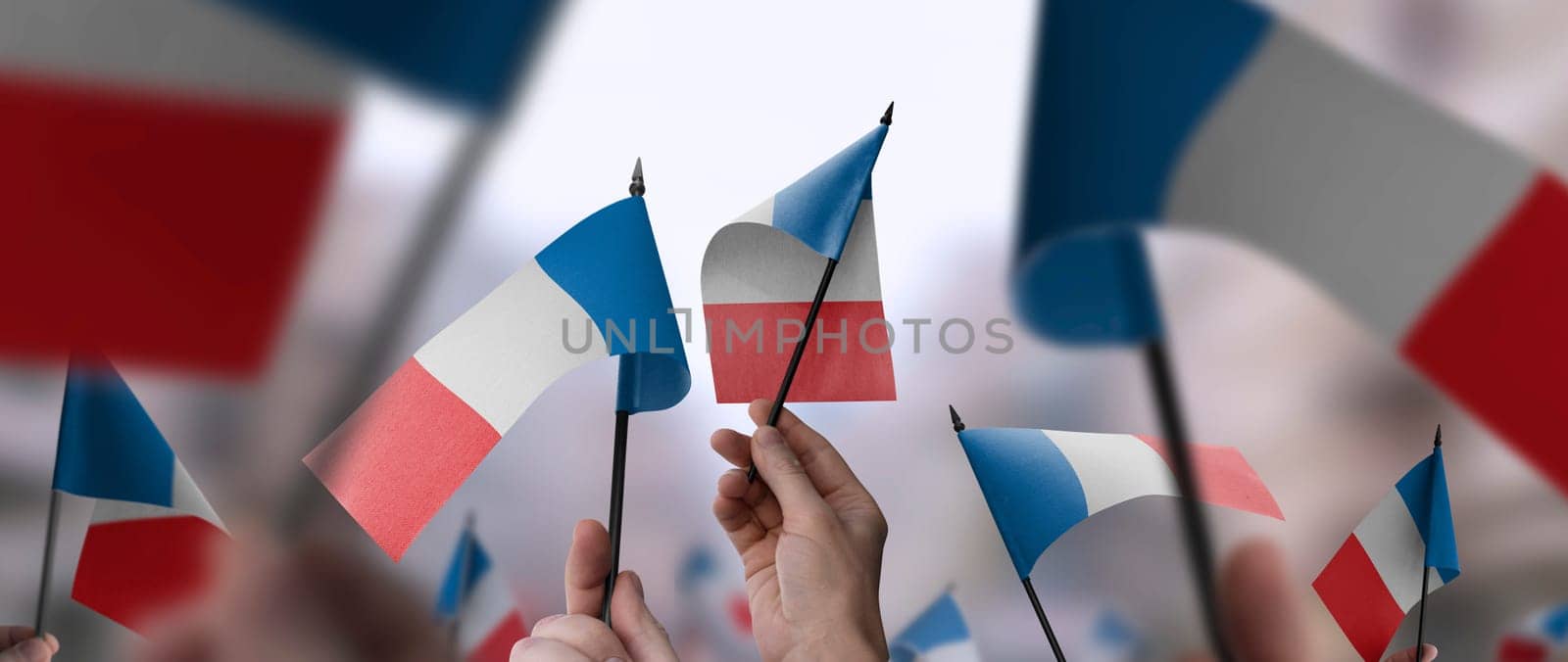 France flags in their hands on a blurred urban background. The photo illustration was created without the use of artificial intelligence, only using Photoshop.