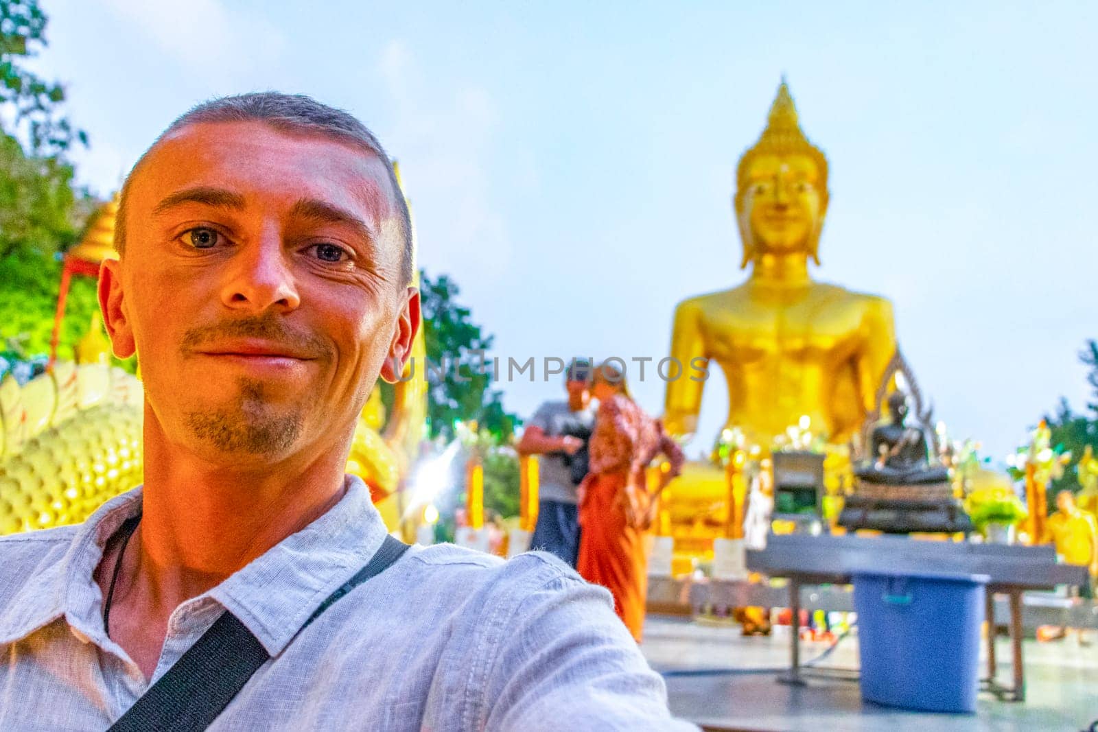 Handsome Man Tourist at the Wat Phra Yai Big Golden Buddha Temple on Phra Tamnak Mountain Hill in Pattaya Bang Lamung Amphoe Chon Buri Thailand.