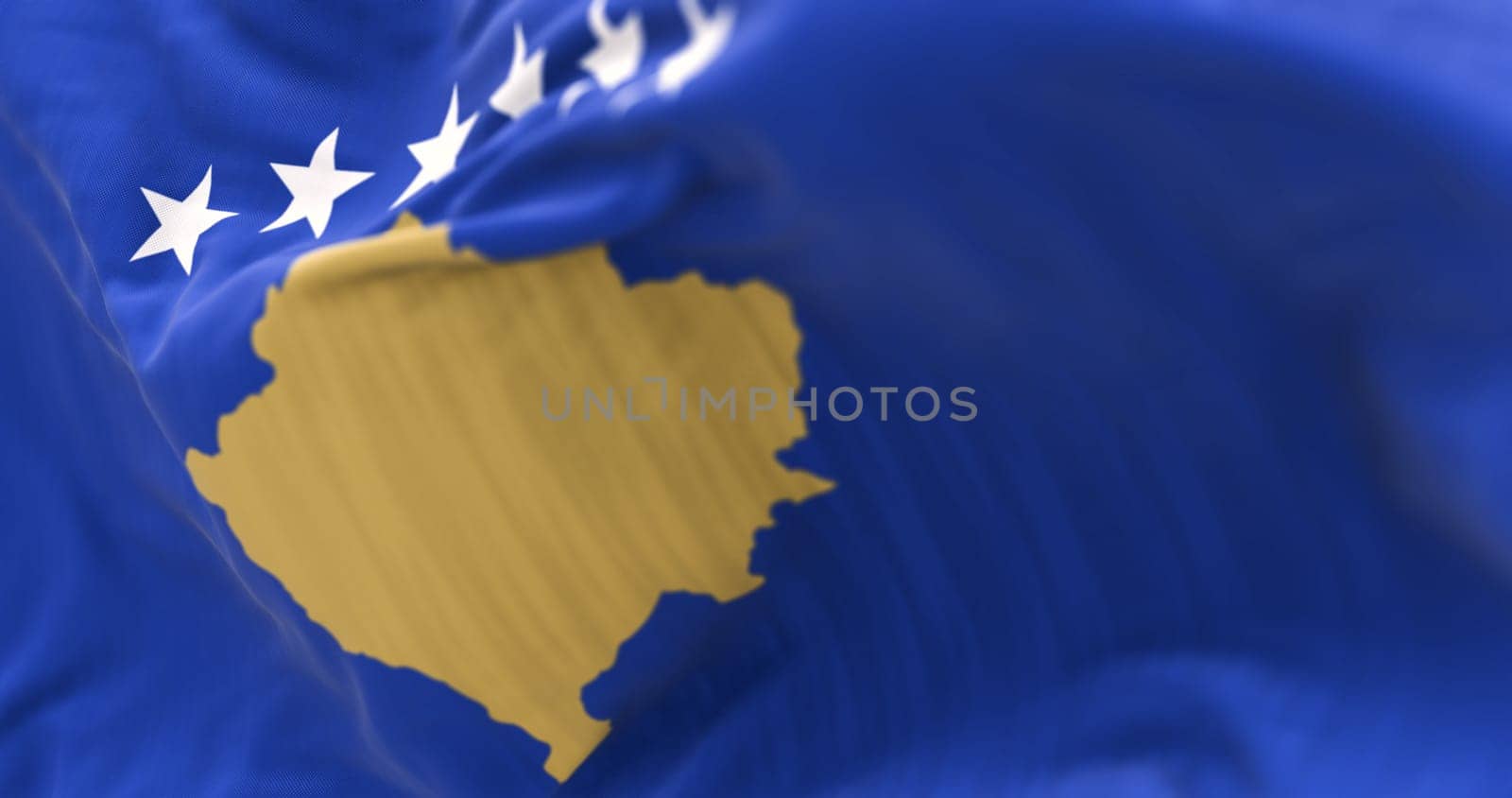 Close-up of Kosovo national flag waving in the wind. Six white stars above a golden map of Kosovo in a blue field. 3d illustration render. Rippling textured fabric. Selective focus