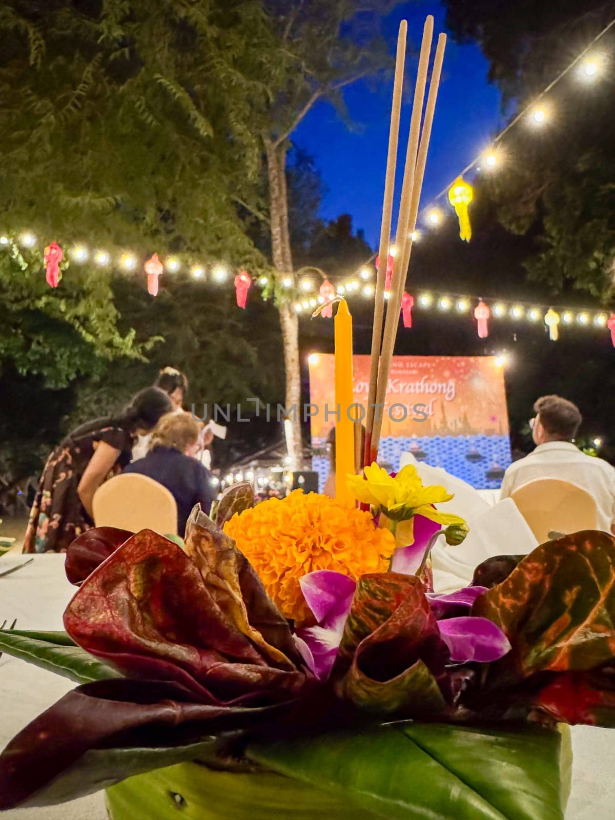 Bangkok, Thailand - November 10, 2024: Traditional floral arrangement for a religious Thai ritual floating on water, sacred tribute featuring colorful flowers. Loy Krathong spiritual ceremony.