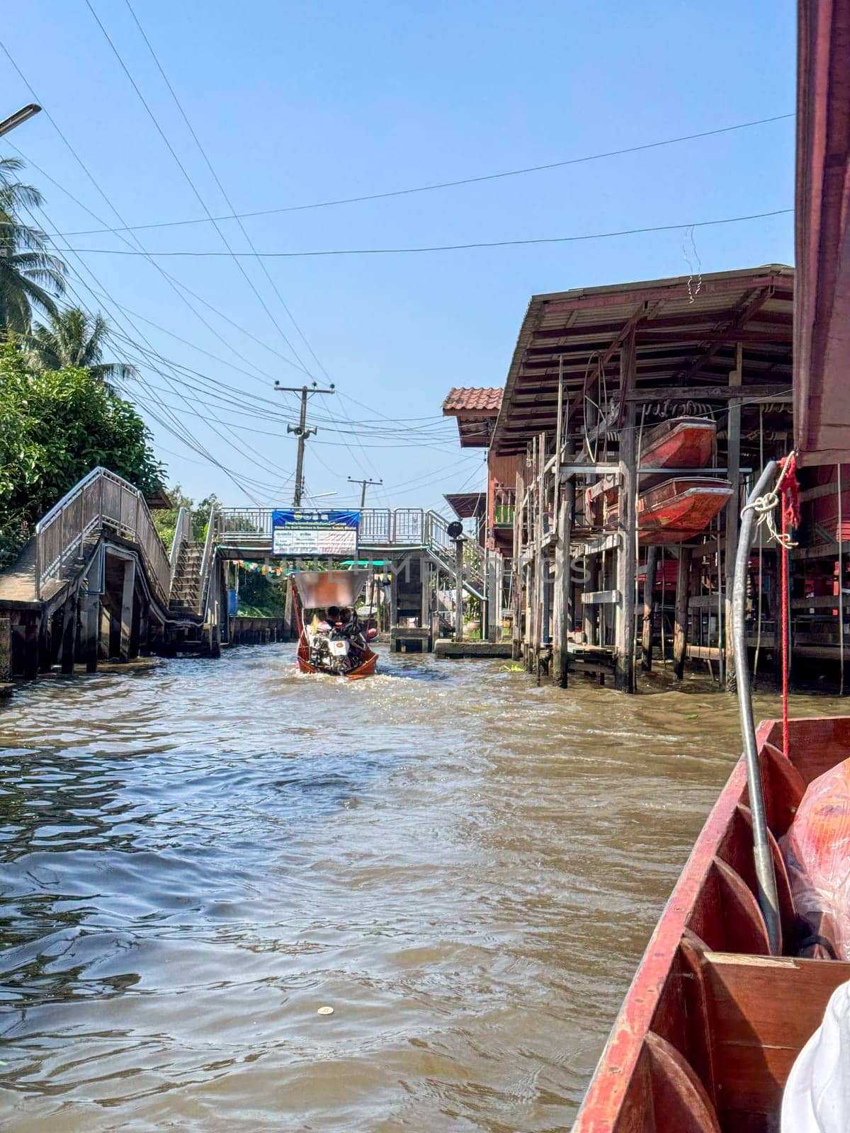 Bangkok, Thailand - November 12, 2024: Colorful floating market with boats selling food, local bazaar where vendors sell Thai seafood or traditional produce. Authentic cultural experience.