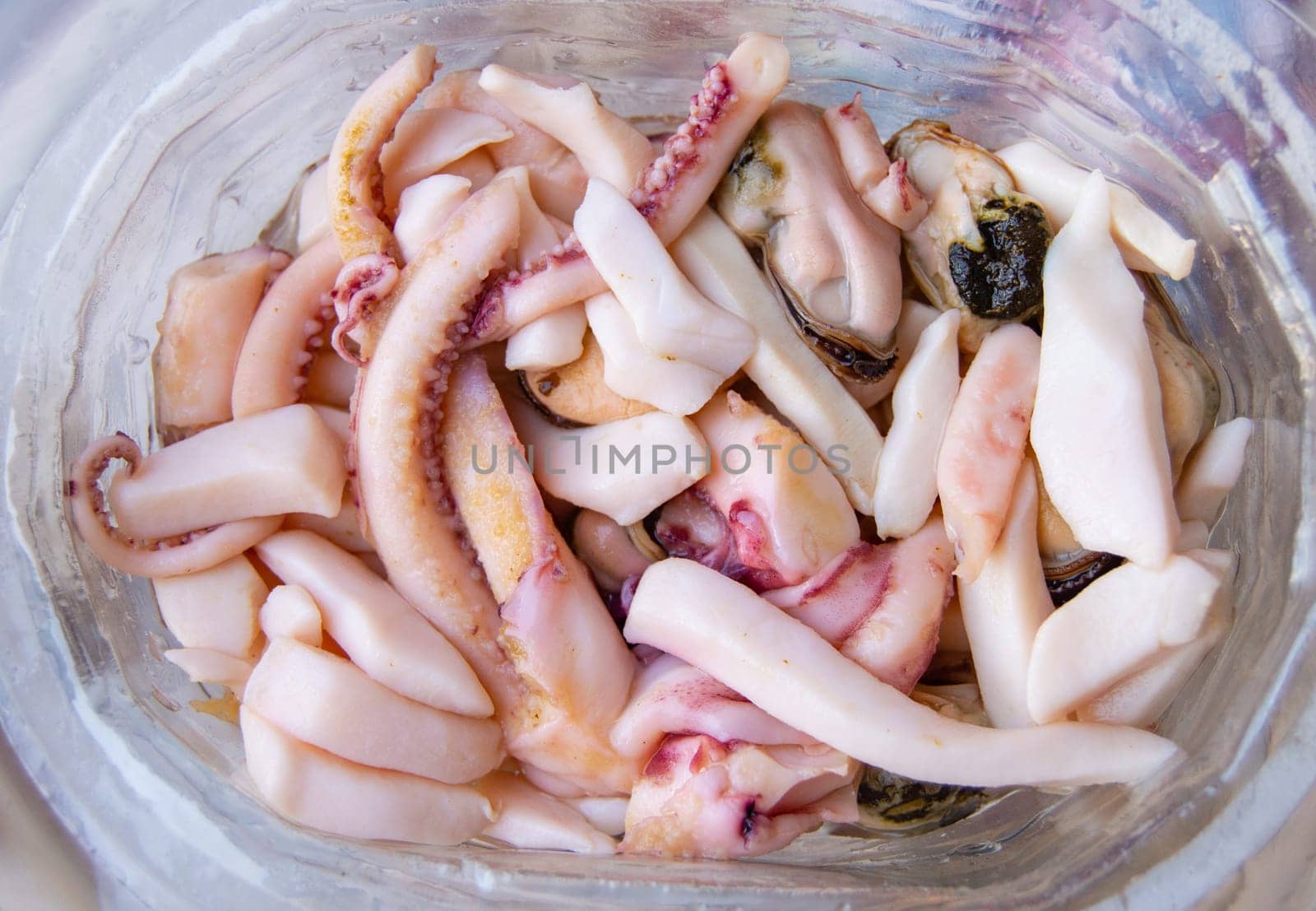 Top view of seafood, ready to eat tentacles and squid, food background.