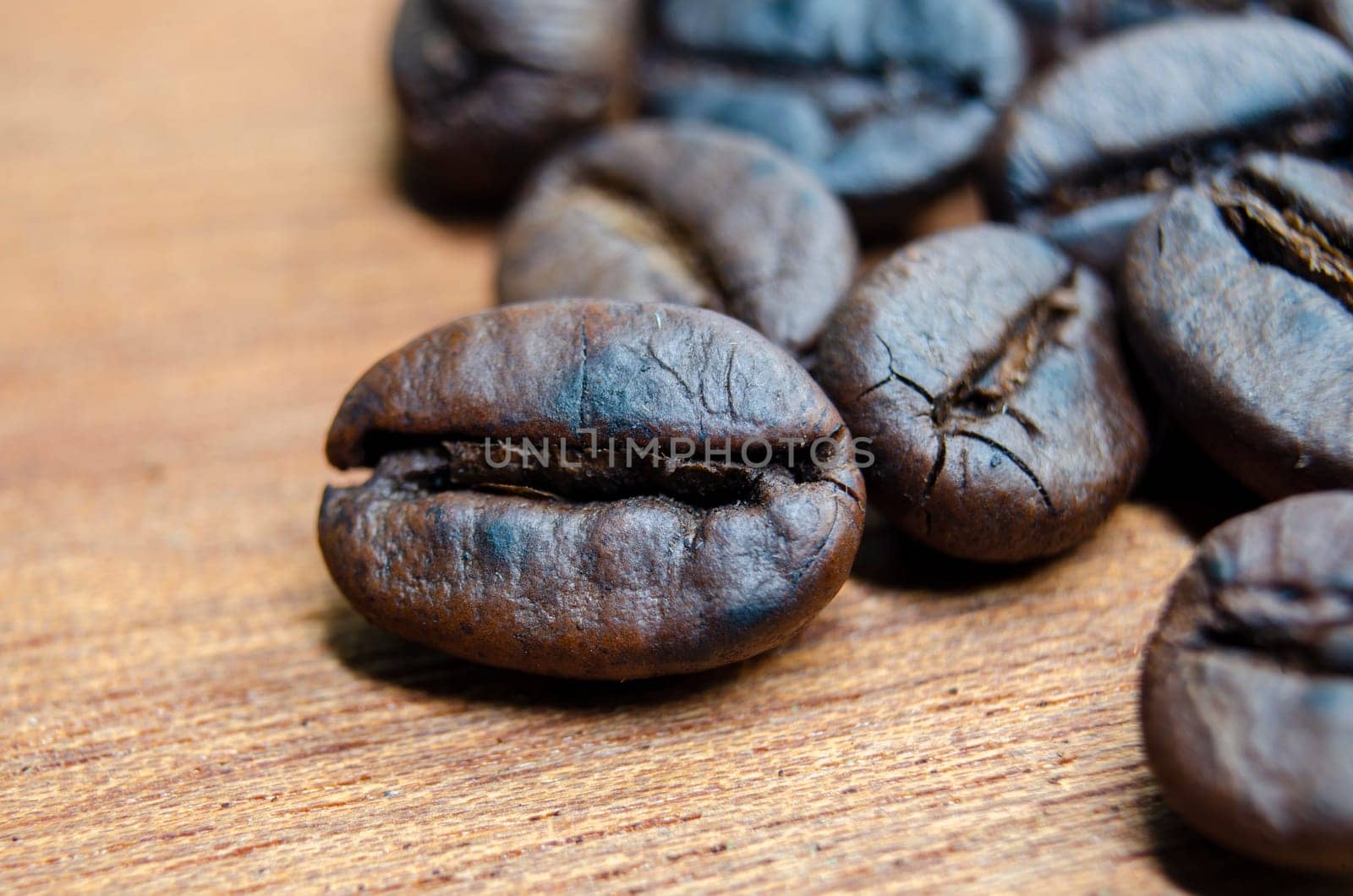 Side view of micro photography of roasted coffee beans with customizable space for text.